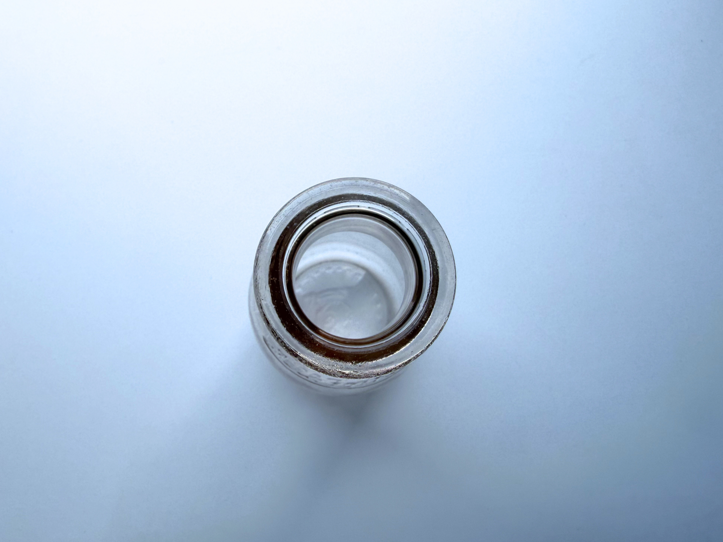 Overhead view looking down into the neck of a vintage Milk for Health glass milk bottle