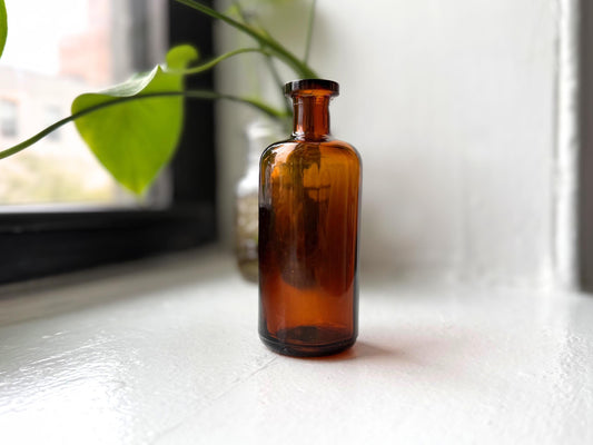 Amber cork-top apothecary bottle full front view, 1950s pharmacy glass, NYC beach recovery