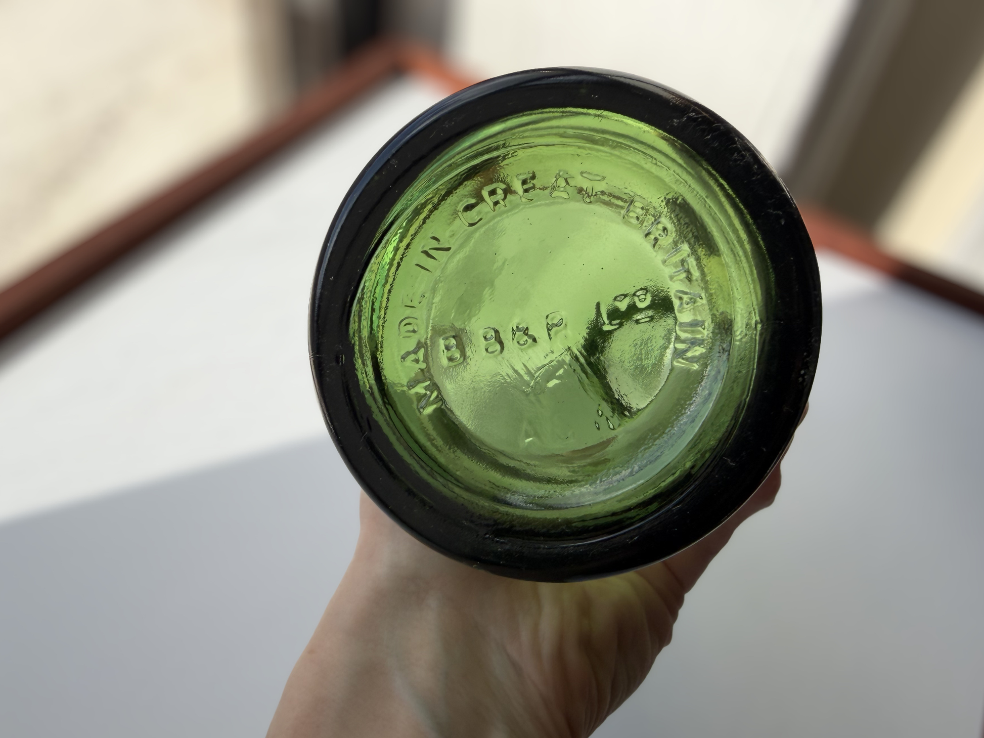 Berry Bros and Rudd bottle shoulder showing embossing detail where shoulder meets neck on green glass form