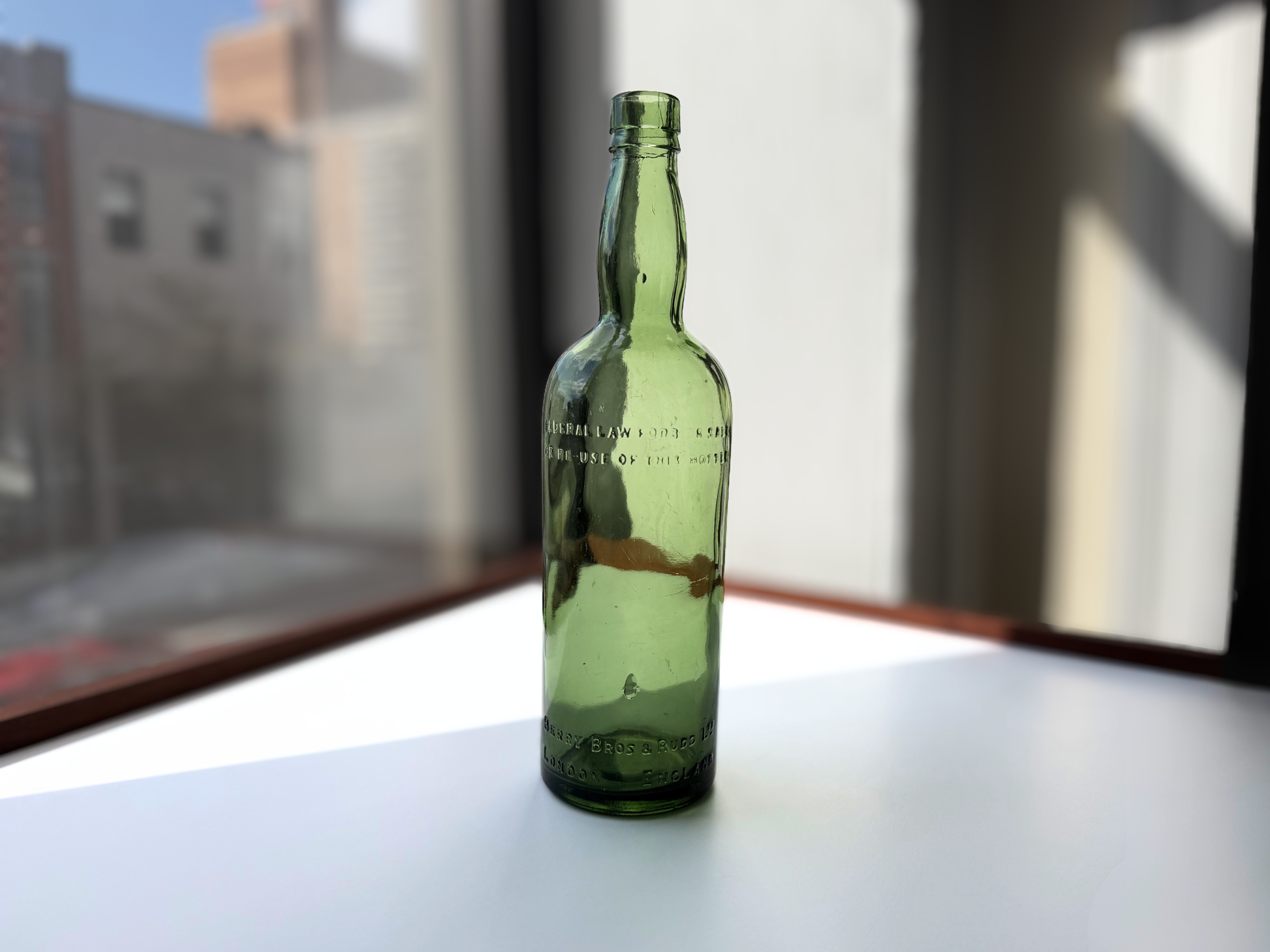 Berry Bros and Rudd bottle side view showing green glass depth and minor surface scratches noted in listing