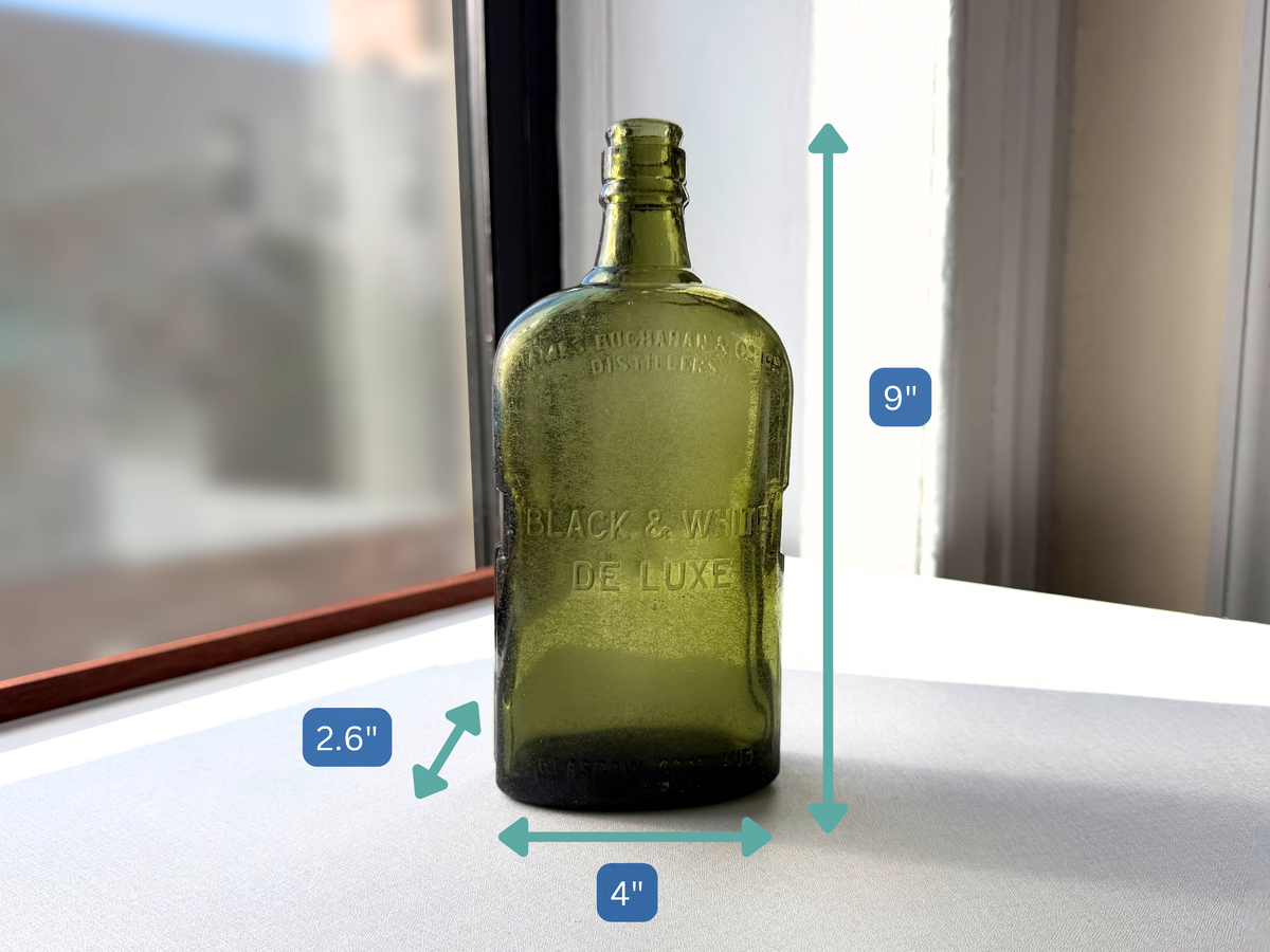 Black and White Deluxe James Buchanan Glasgow Scotland bottle, Federal Law green glass, seaworn patina from NYC recovery