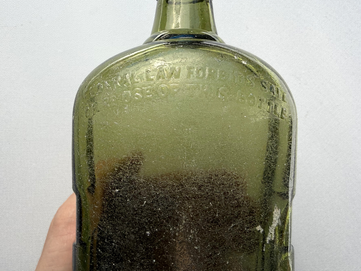 Antique Black and White Deluxe Scotch bottle in green glass with seaworn patina, vintage Scottish distillery collectible