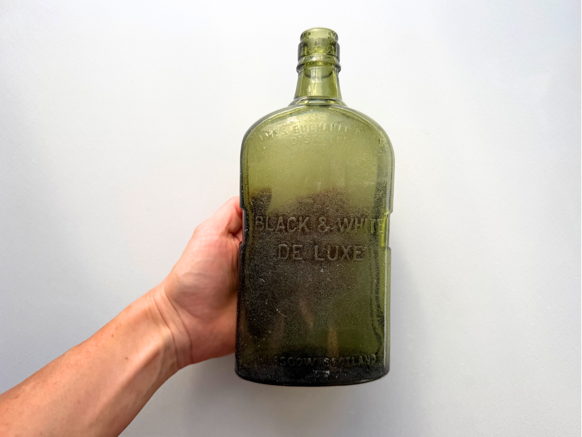 James Buchanan and Co Black and White Deluxe bottle base detail showing UGB marking, antique green glass barware