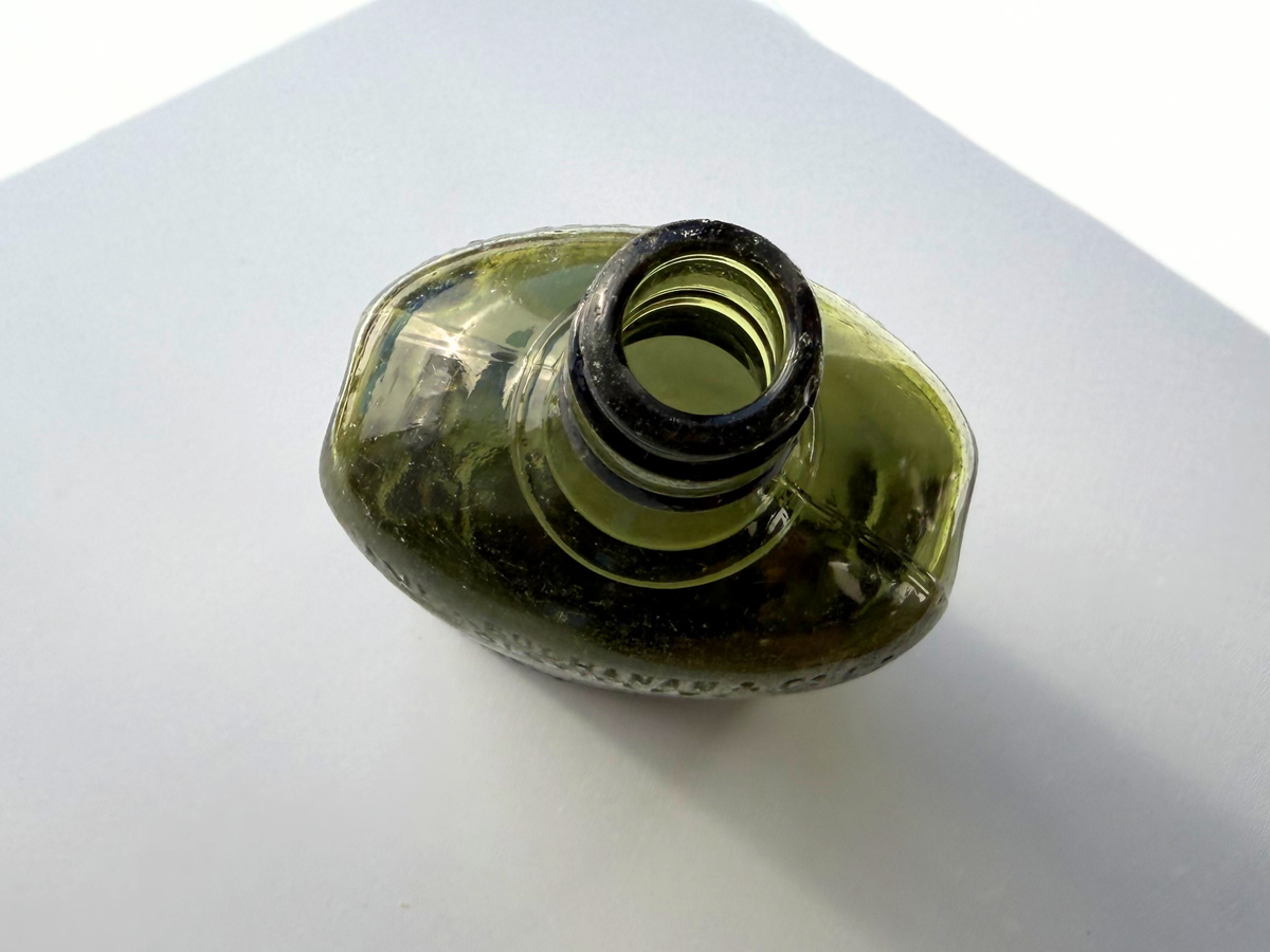 Vintage Black and White Deluxe Scotch bottle profile, green glass with minor seaworn character, NYC beach recovery