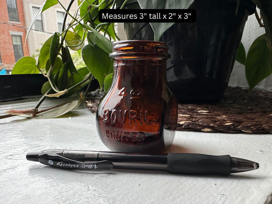 Bovril jar side view showing compact amber glass form and warm amber color of British production glass