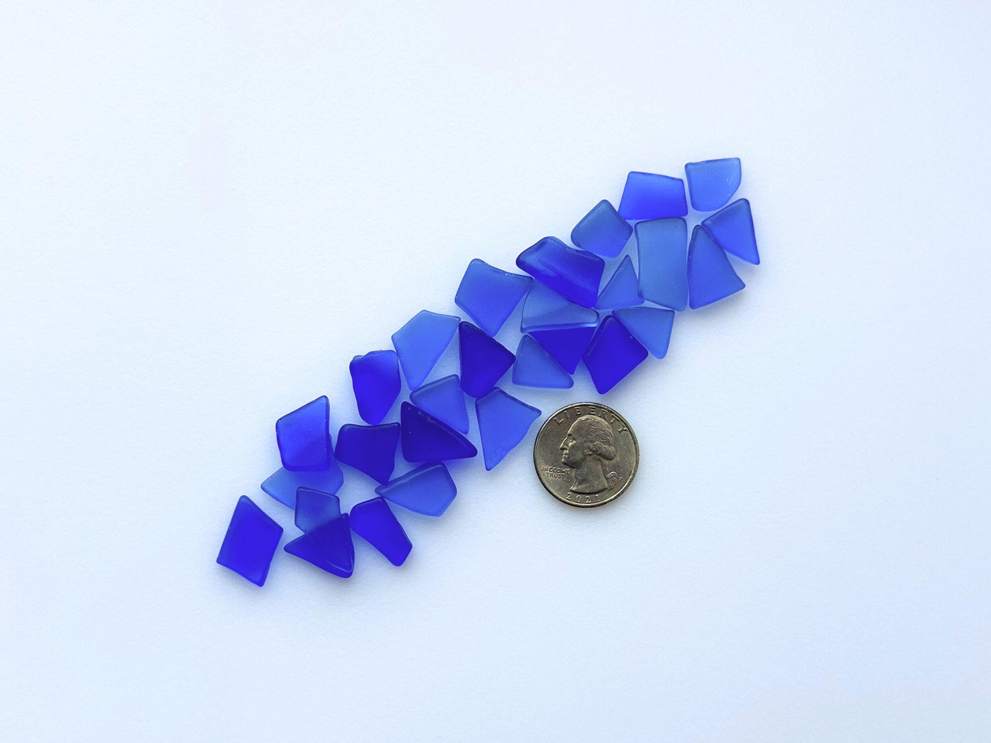 Scattered deep blue sea glass with quarter – real beach glass curated for crafting