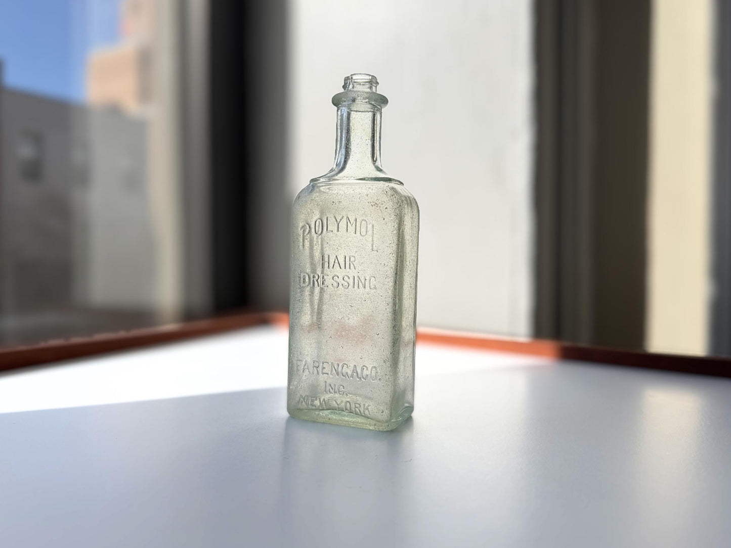 Antique aqua Polymol Hair Dressing bottle with genuine sea-worn ocean patina. Early 20th century New York glass transformed by decades at sea into frosted sea glass. Perfect beach house decor and vintage collector piece.