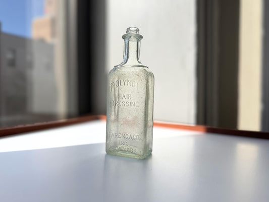 Antique aqua Polymol Hair Dressing bottle with genuine sea-worn ocean patina. Early 20th century New York glass transformed by decades at sea into frosted sea glass. Perfect beach house decor and vintage collector piece.