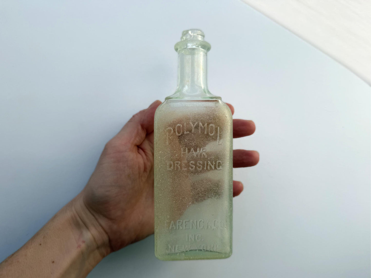 Antique aqua Polymol Hair Dressing bottle with genuine sea-worn ocean patina. Early 20th century New York glass transformed by decades at sea into frosted sea glass. Perfect beach house decor and vintage collector piece.