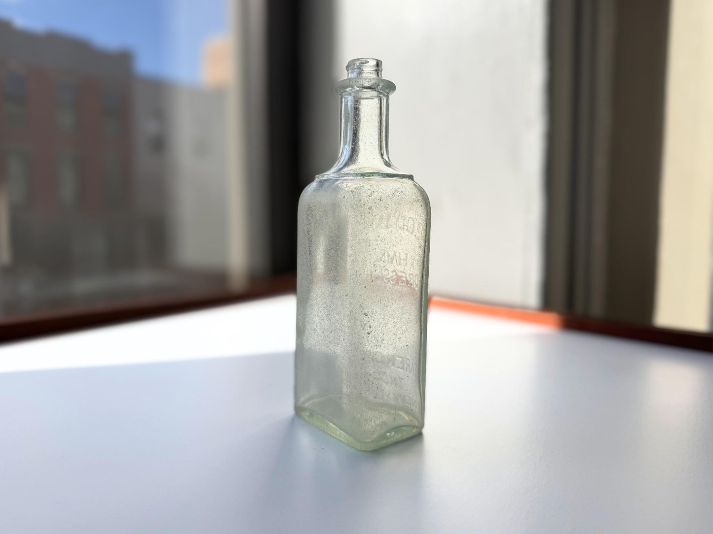 Antique aqua Polymol Hair Dressing bottle with genuine sea-worn ocean patina. Early 20th century New York glass transformed by decades at sea into frosted sea glass. Perfect beach house decor and vintage collector piece.