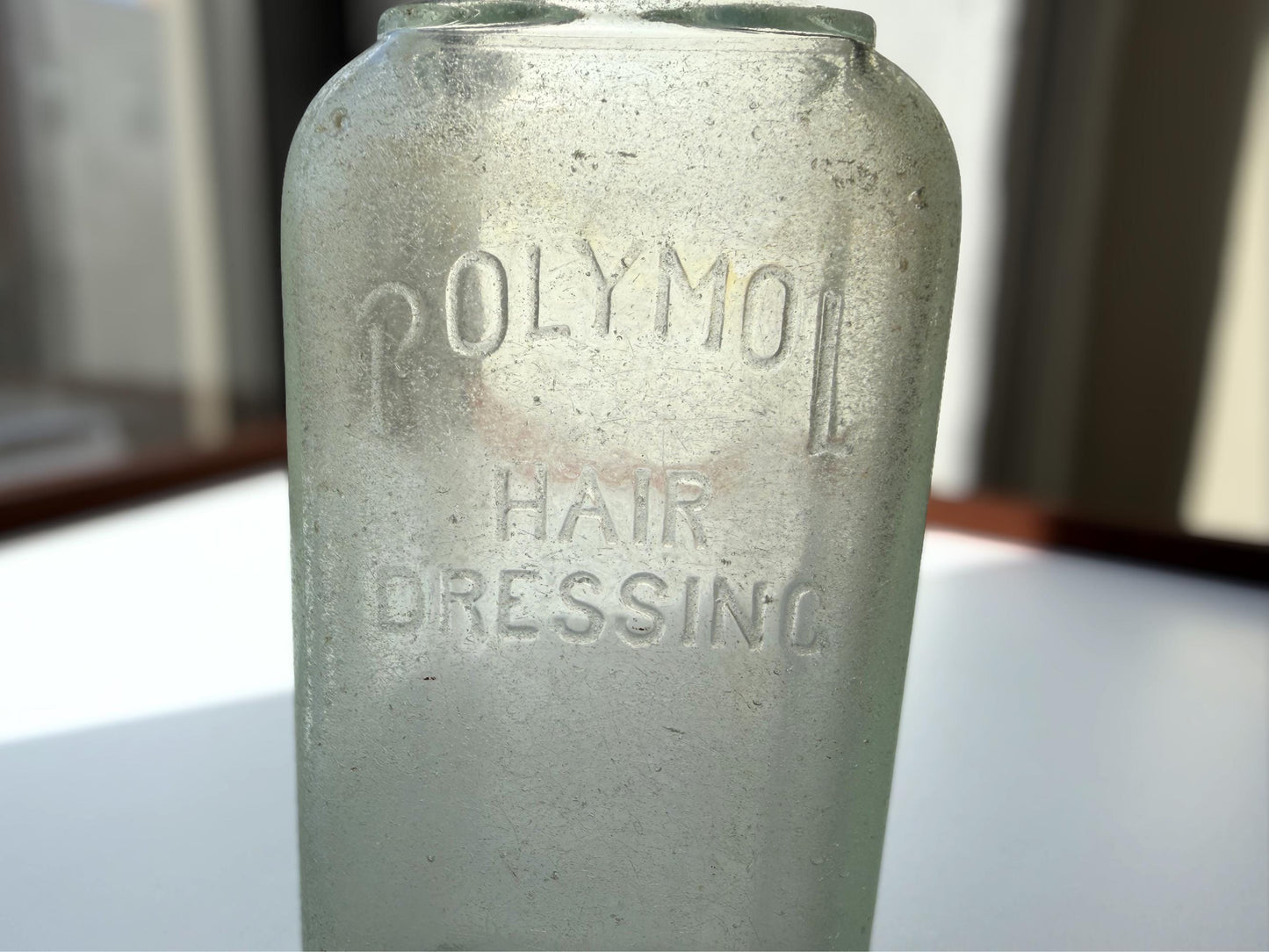Antique aqua Polymol Hair Dressing bottle with genuine sea-worn ocean patina. Early 20th century New York glass transformed by decades at sea into frosted sea glass. Perfect beach house decor and vintage collector piece.