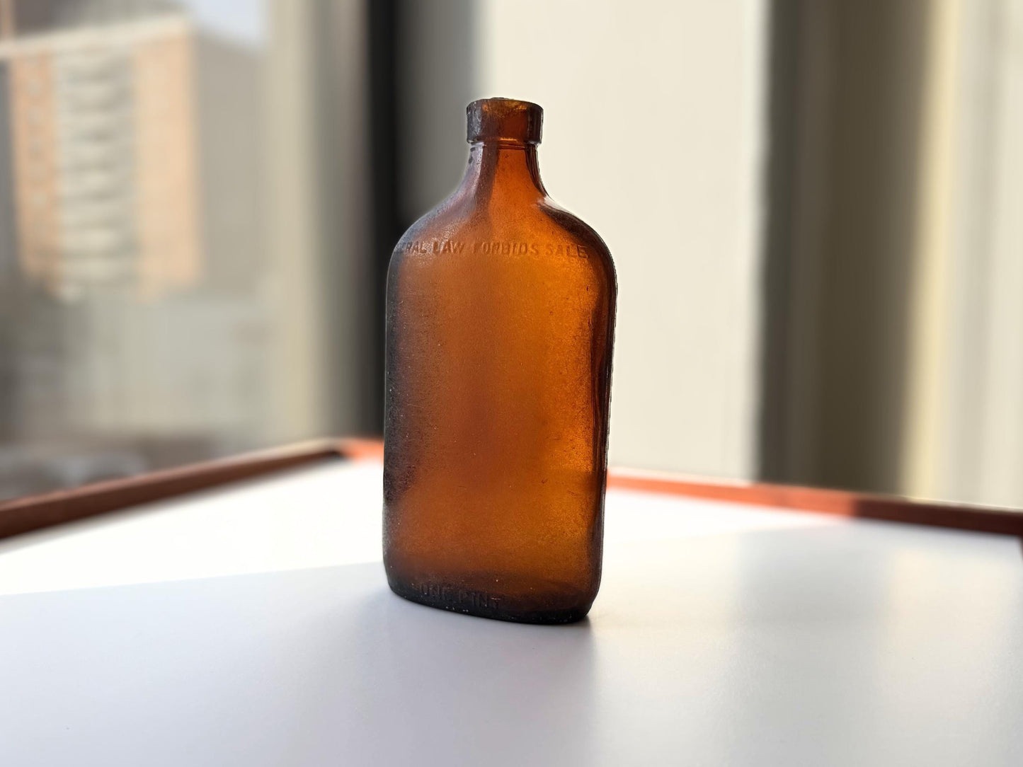 Authentic 1953 amber pint flask 7.75 inches tall with heavy all-over sea-worn patina and Federal Law embossing - genuine beach-found NYC sea glass hand-recovered from NYC shorelines