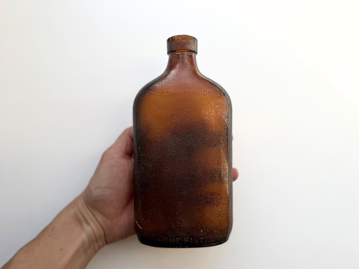 Authentic 1953 amber pint flask 7.75 inches tall with heavy all-over sea-worn patina and Federal Law embossing - genuine beach-found NYC sea glass hand-recovered from NYC shorelines