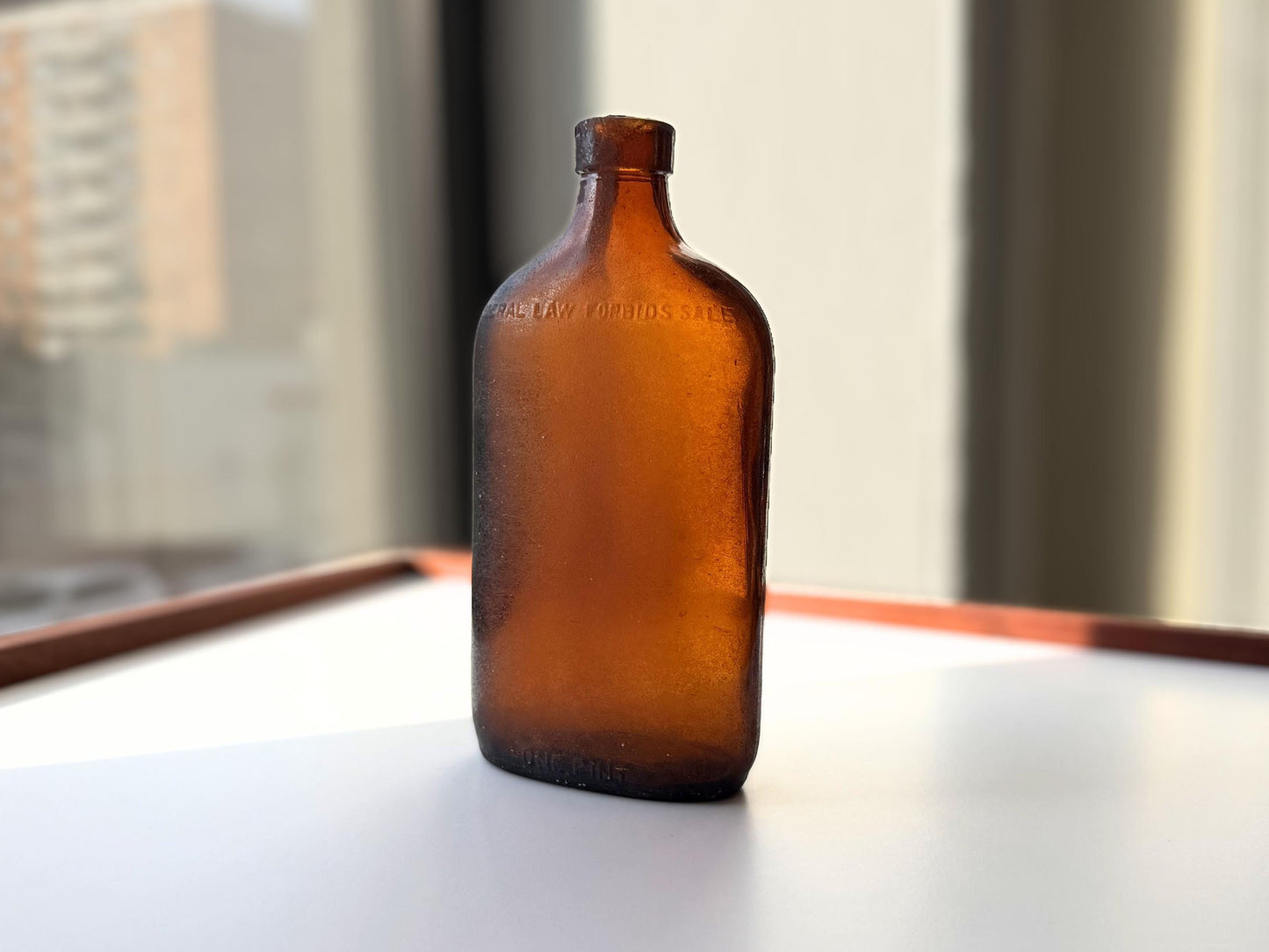 Authentic 1953 amber pint flask 7.75 inches tall with heavy all-over sea-worn patina and Federal Law embossing - genuine beach-found NYC sea glass hand-recovered from NYC shorelines