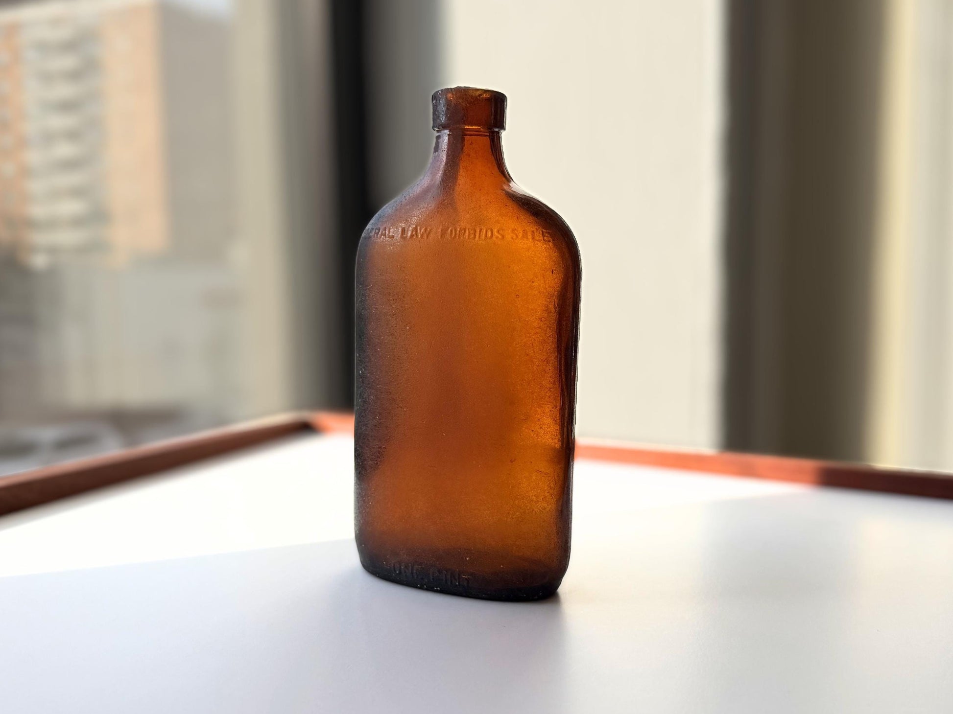 Authentic 1953 amber pint flask 7.75 inches tall with heavy all-over sea-worn patina and Federal Law embossing - genuine beach-found NYC sea glass hand-recovered from NYC shorelines
