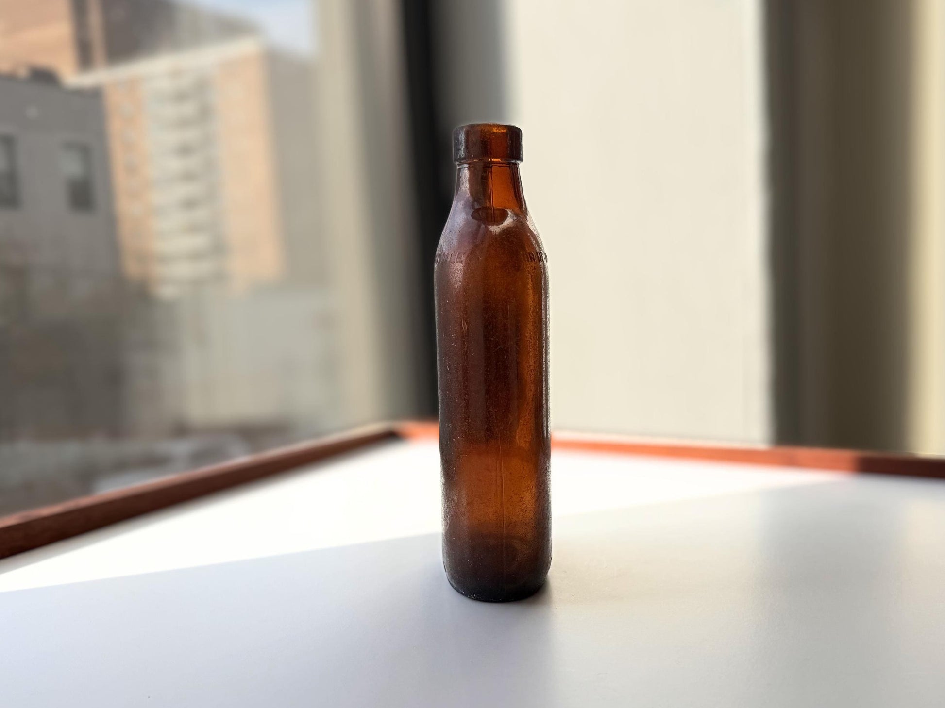 Authentic 1953 amber pint flask 7.75 inches tall with heavy all-over sea-worn patina and Federal Law embossing - genuine beach-found NYC sea glass hand-recovered from NYC shorelines