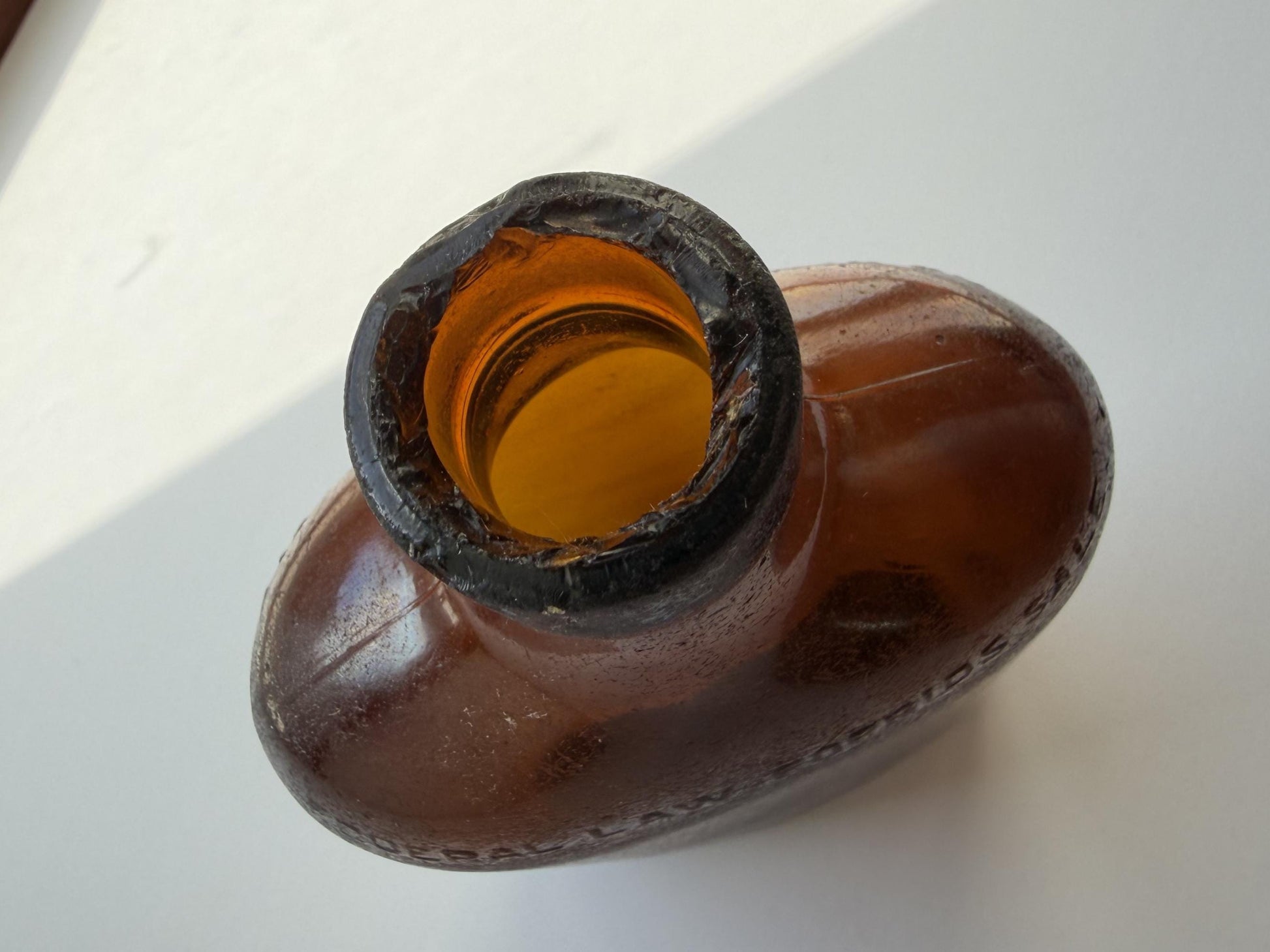 Authentic 1953 amber pint flask 7.75 inches tall with heavy all-over sea-worn patina and Federal Law embossing - genuine beach-found NYC sea glass hand-recovered from NYC shorelines