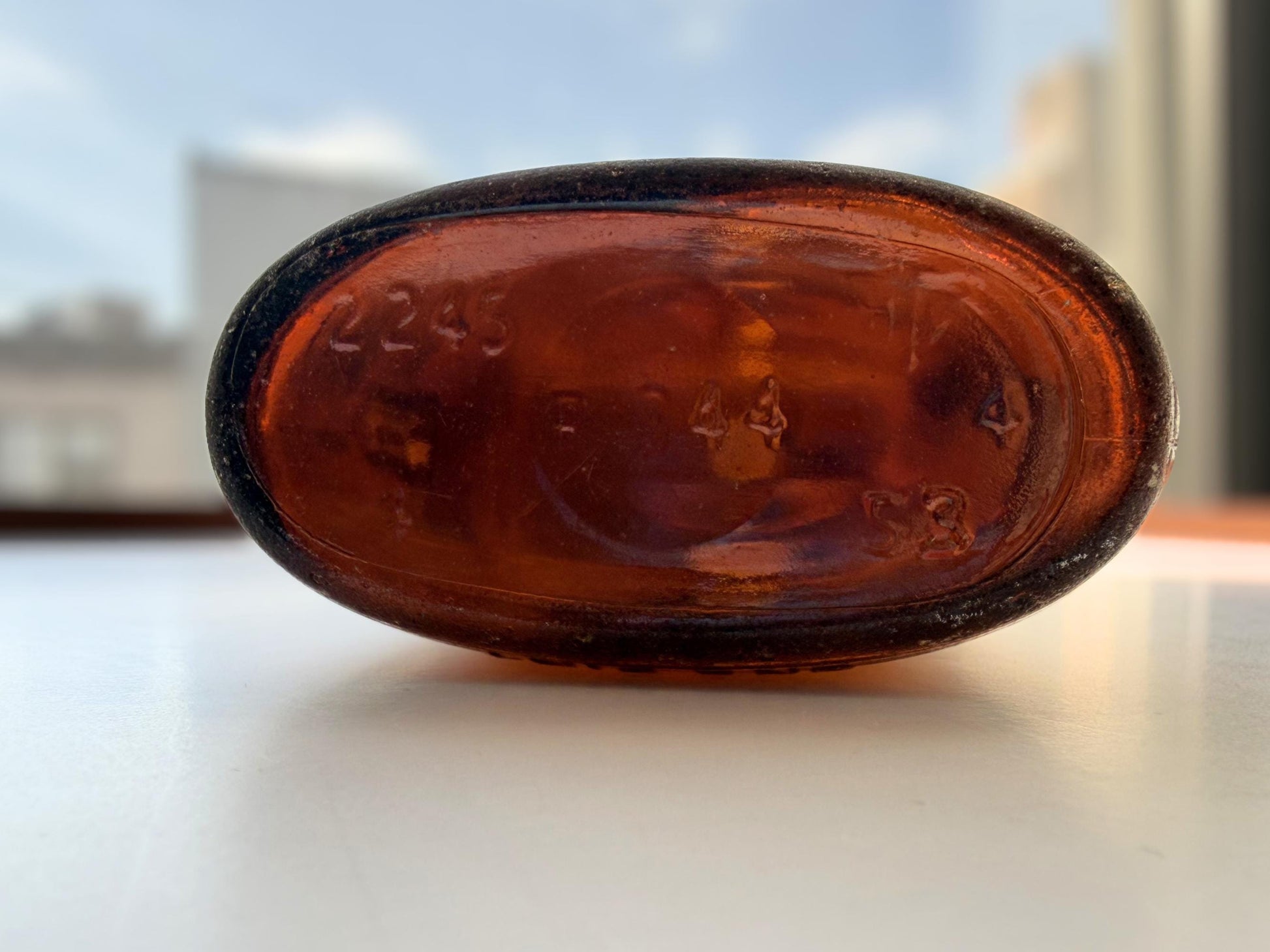 Authentic 1953 amber pint flask 7.75 inches tall with heavy all-over sea-worn patina and Federal Law embossing - genuine beach-found NYC sea glass hand-recovered from NYC shorelines