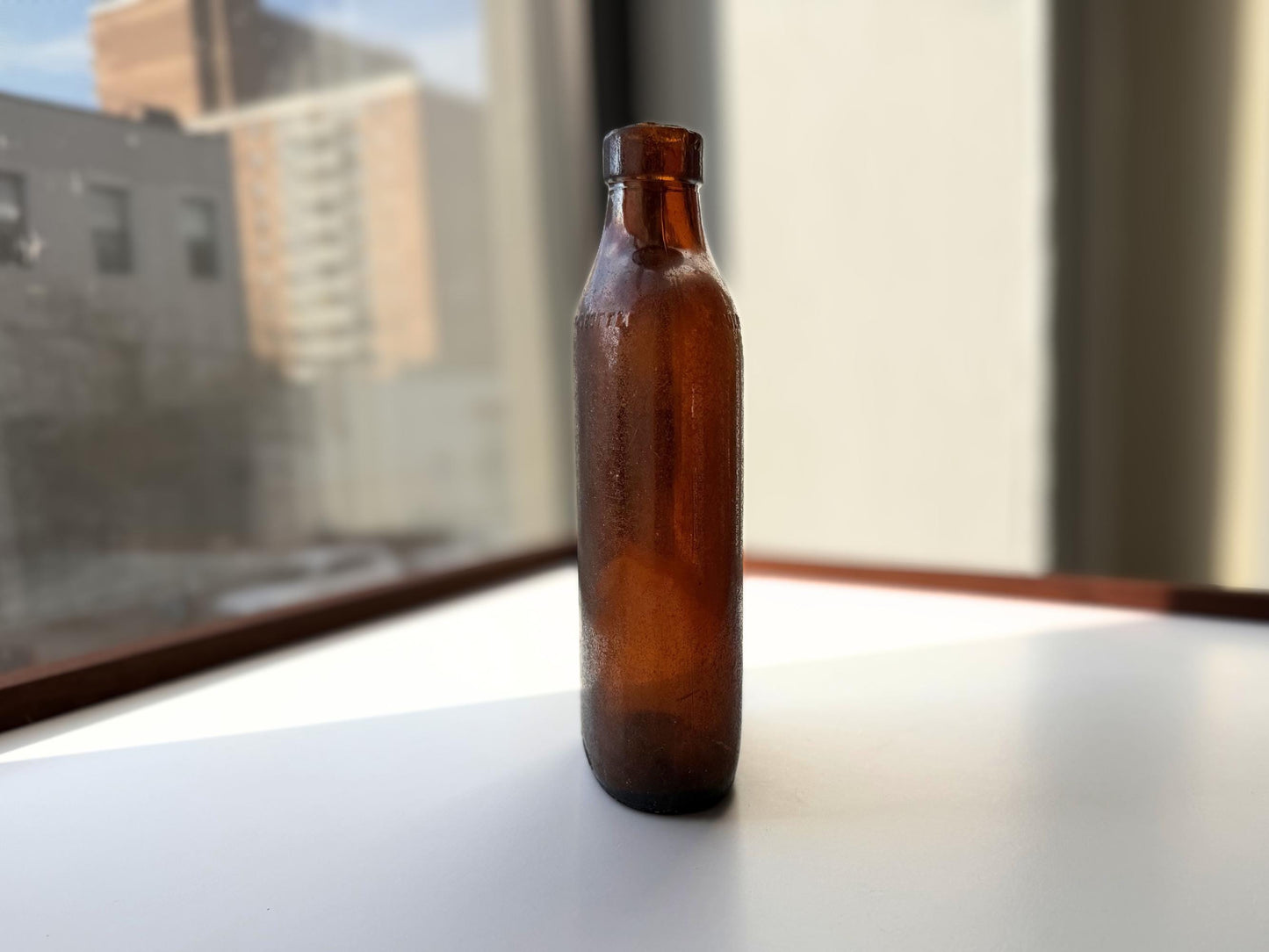 Authentic 1953 amber pint flask 7.75 inches tall with heavy all-over sea-worn patina and Federal Law embossing - genuine beach-found NYC sea glass hand-recovered from NYC shorelines