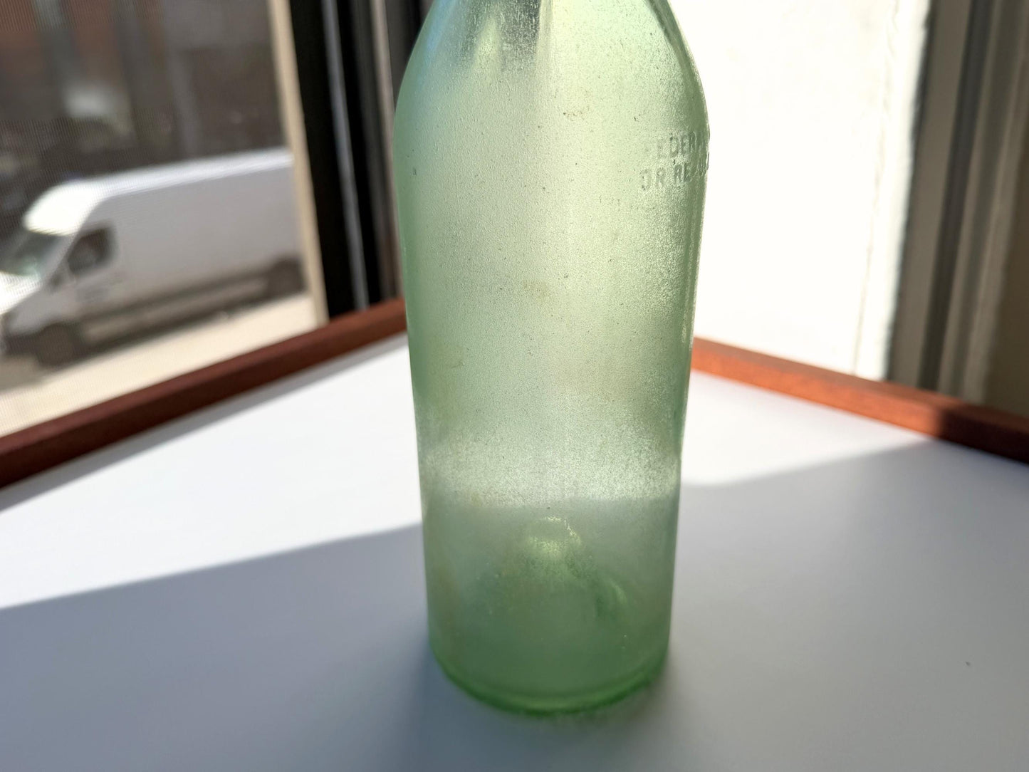 Vintage seaworn Bacardi rum bottle with beautiful frosted patina from ocean exposure. Minor chips showing authentic age. Perfect for sea glass and vintage spirits collectors.