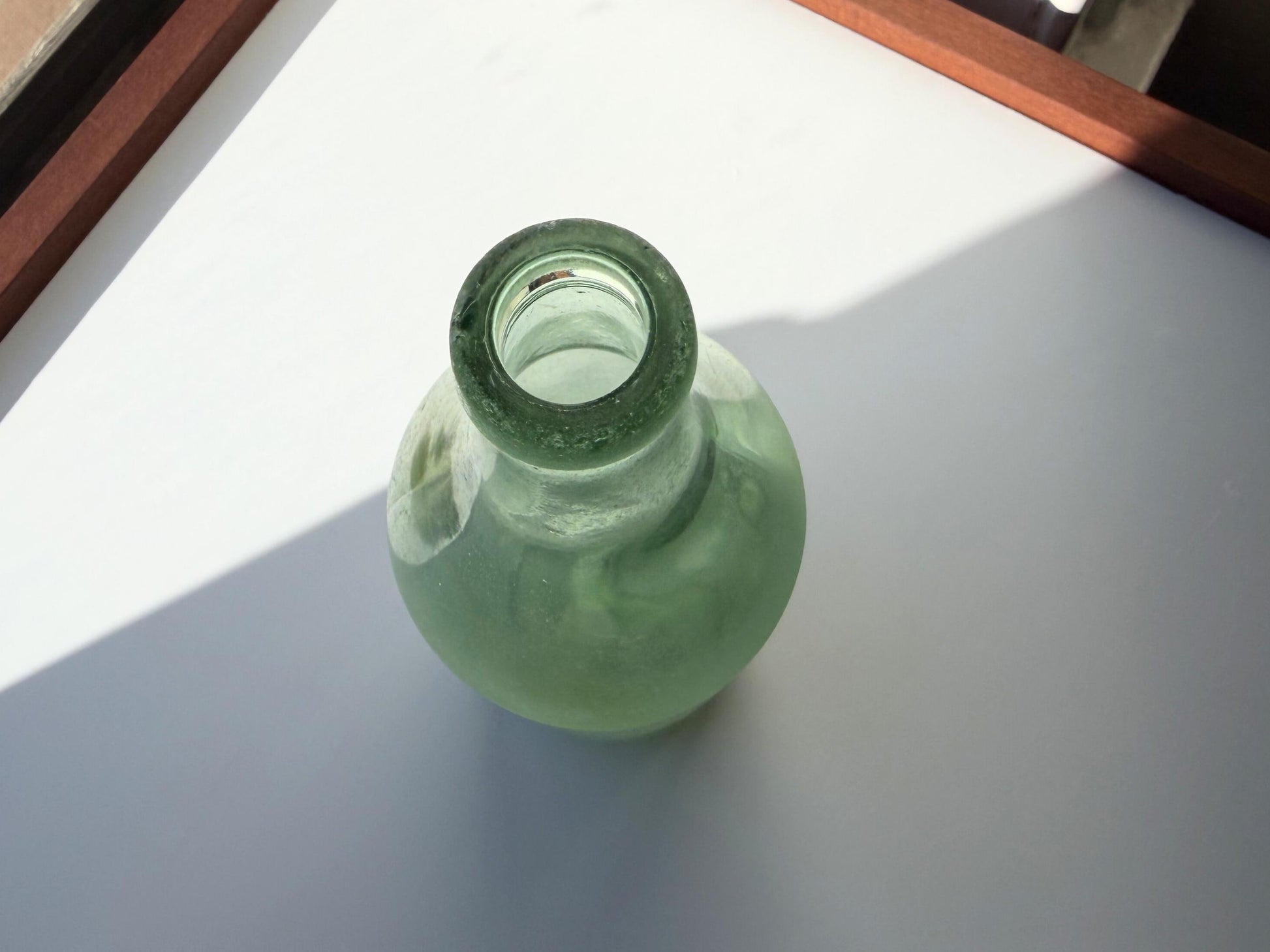 Vintage seaworn Bacardi rum bottle with beautiful frosted patina from ocean exposure. Minor chips showing authentic age. Perfect for sea glass and vintage spirits collectors.