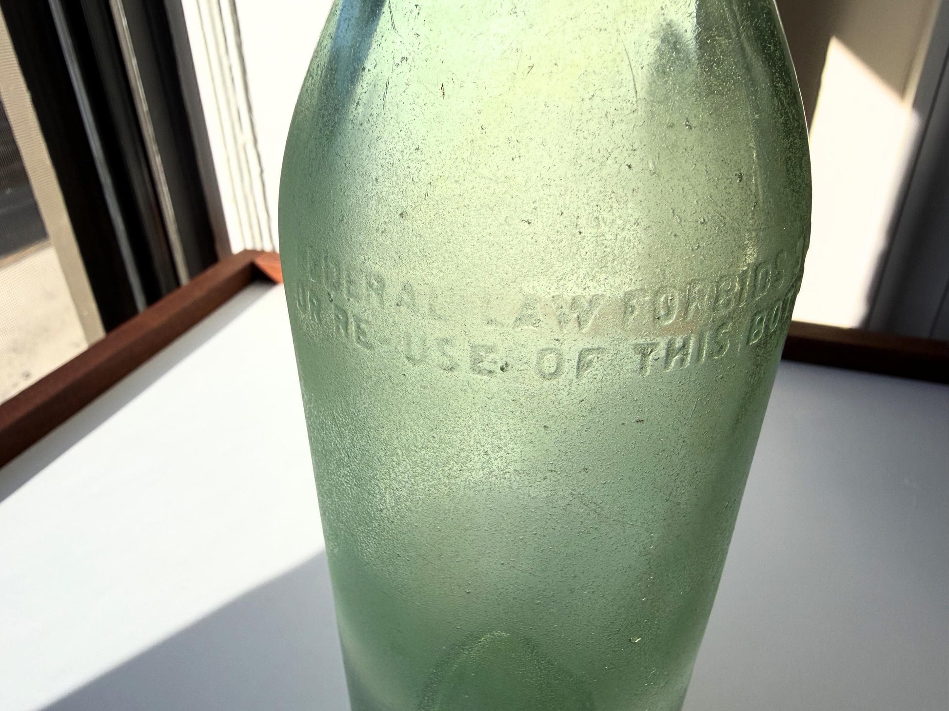 Vintage seaworn Bacardi rum bottle with beautiful frosted patina from ocean exposure. Minor chips showing authentic age. Perfect for sea glass and vintage spirits collectors.