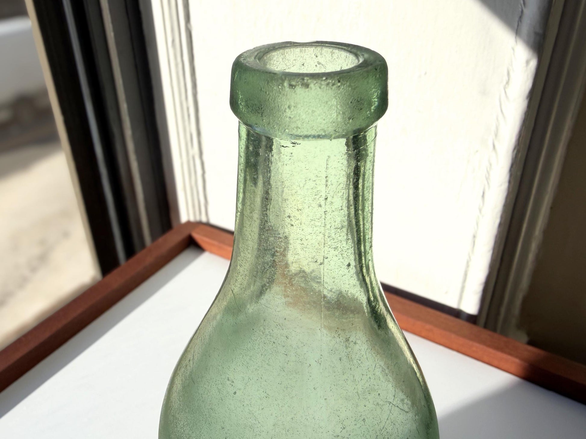 Vintage seaworn Bacardi rum bottle with beautiful frosted patina from ocean exposure. Minor chips showing authentic age. Perfect for sea glass and vintage spirits collectors.