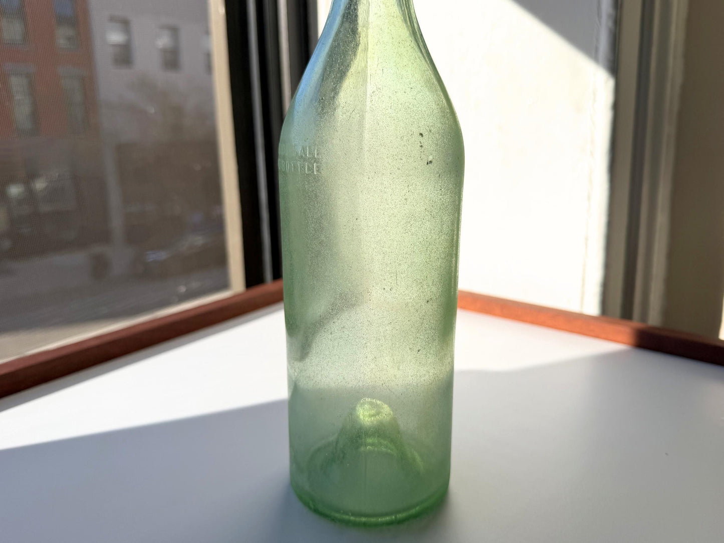 Vintage seaworn Bacardi rum bottle with beautiful frosted patina from ocean exposure. Minor chips showing authentic age. Perfect for sea glass and vintage spirits collectors.