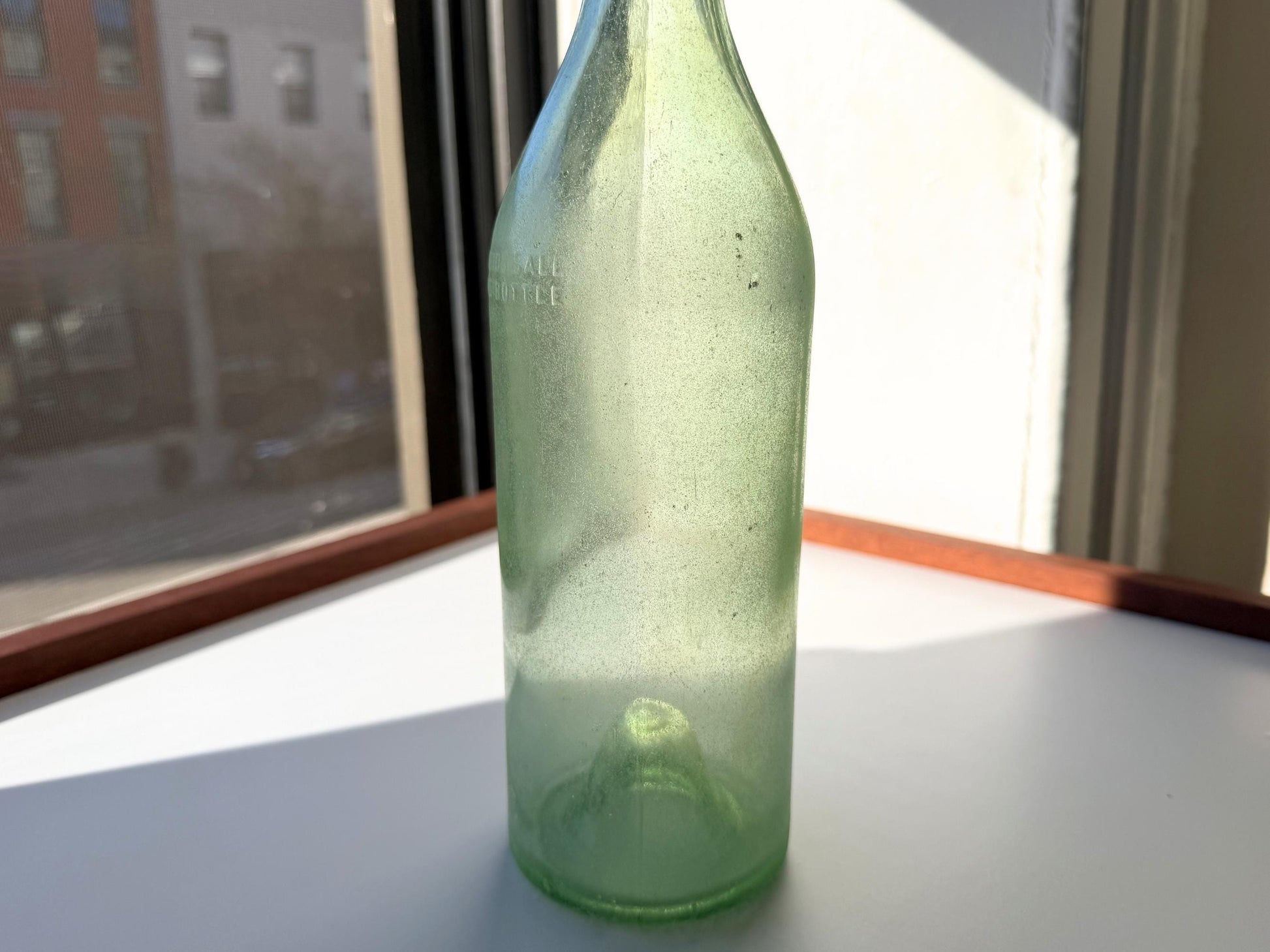 Vintage seaworn Bacardi rum bottle with beautiful frosted patina from ocean exposure. Minor chips showing authentic age. Perfect for sea glass and vintage spirits collectors.