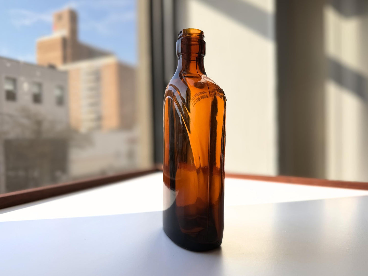 Vintage 1949 amber glass spirits flask 8.25 inches tall with Federal Law embossing around shoulder - clean mid-century collector piece hand-recovered from NYC