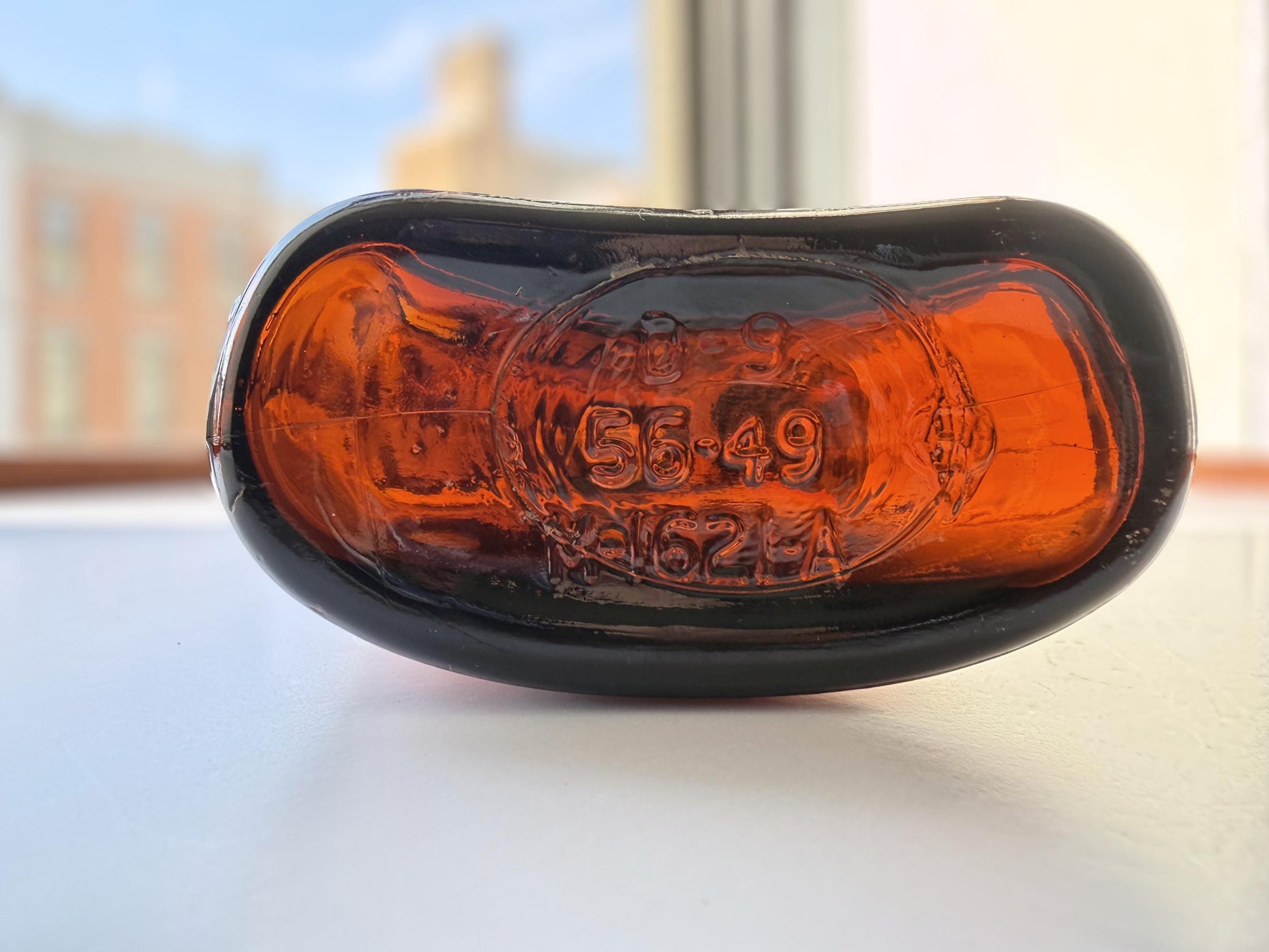Vintage 1949 amber glass spirits flask 8.25 inches tall with Federal Law embossing around shoulder - clean mid-century collector piece hand-recovered from NYC