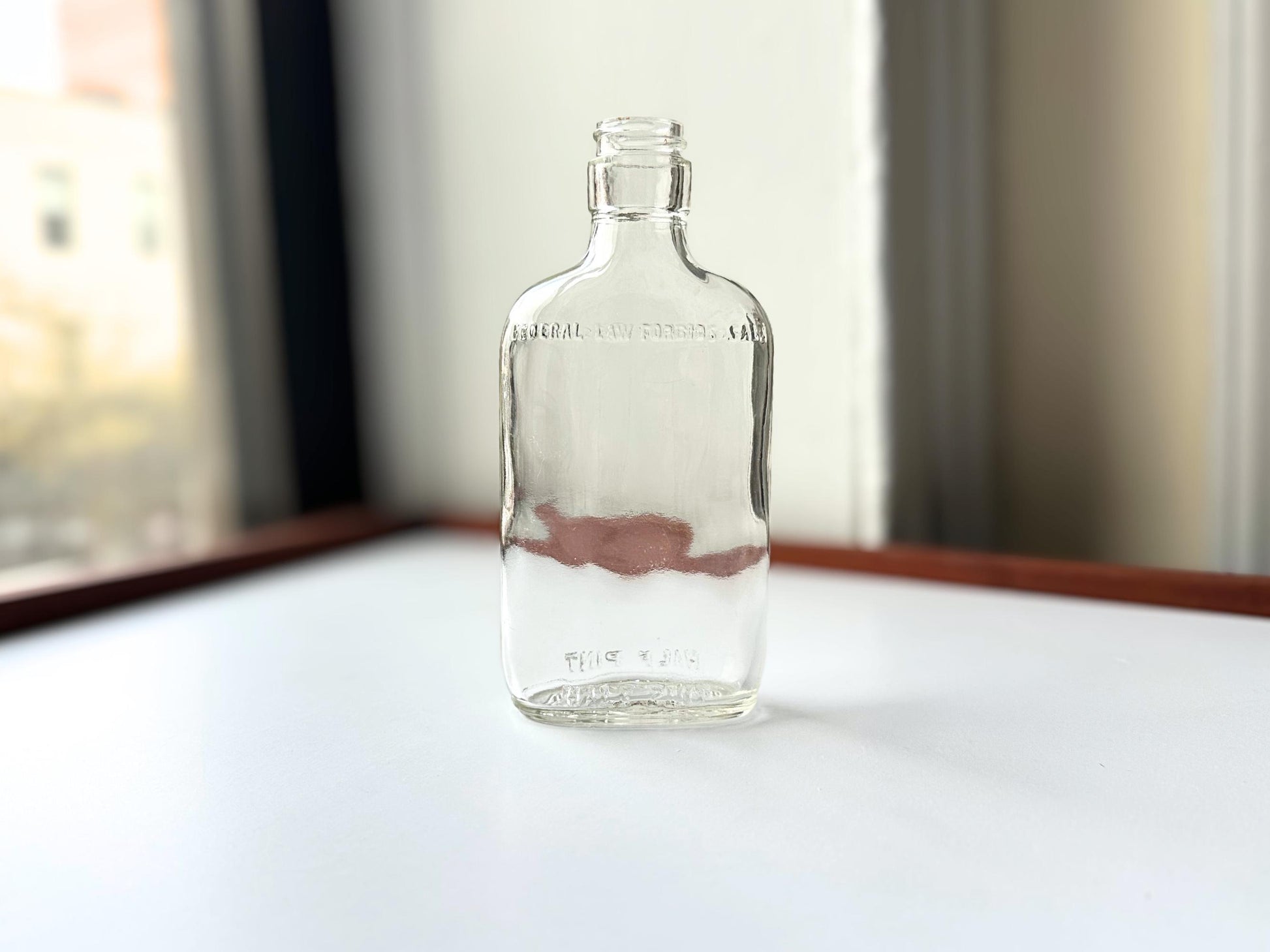 Vintage 1950 Clear Glass Flask Bottle Federal Law – close-up – Brooklyn Sea Glass