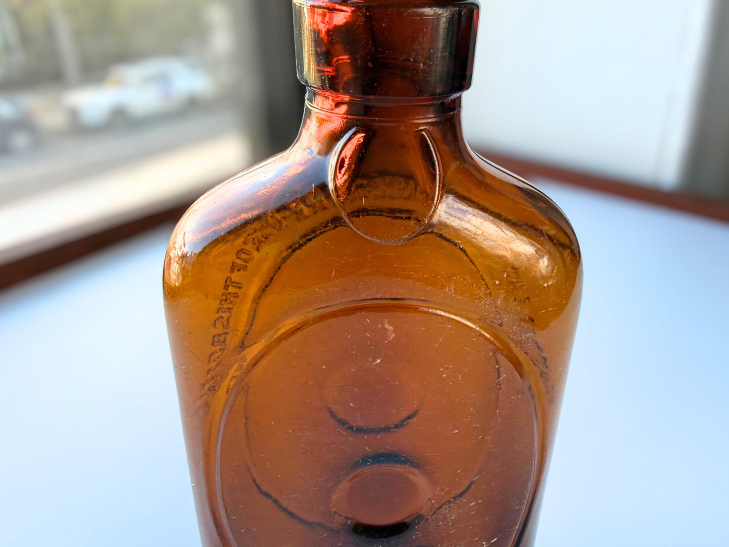 Vintage 1950s amber glass liquor flask 6.75 inches tall with oval embossing and Federal Law prohibition warning. Art Deco oval design, rescued from NYC historic landfills – Brooklyn Sea Glass