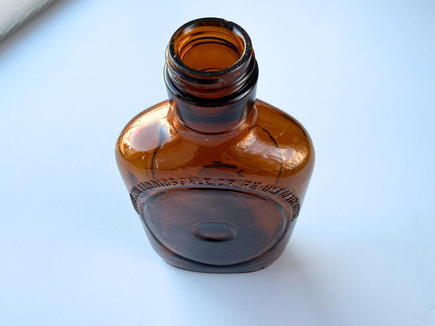 Vintage 1950s amber glass liquor flask 6.75 inches tall with oval embossing and Federal Law prohibition warning. Art Deco oval design, rescued from NYC historic landfills – Brooklyn Sea Glass