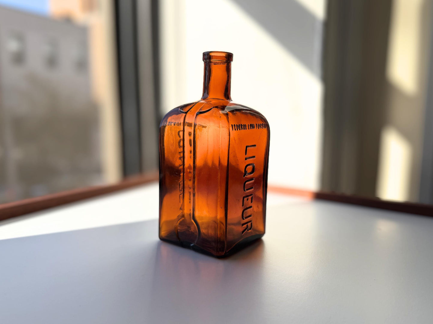 Vintage 1951 large amber Cointreau bottle with 51 production marking. Perfect for spirits collectors, bar displays, and vintage liqueur enthusiasts.