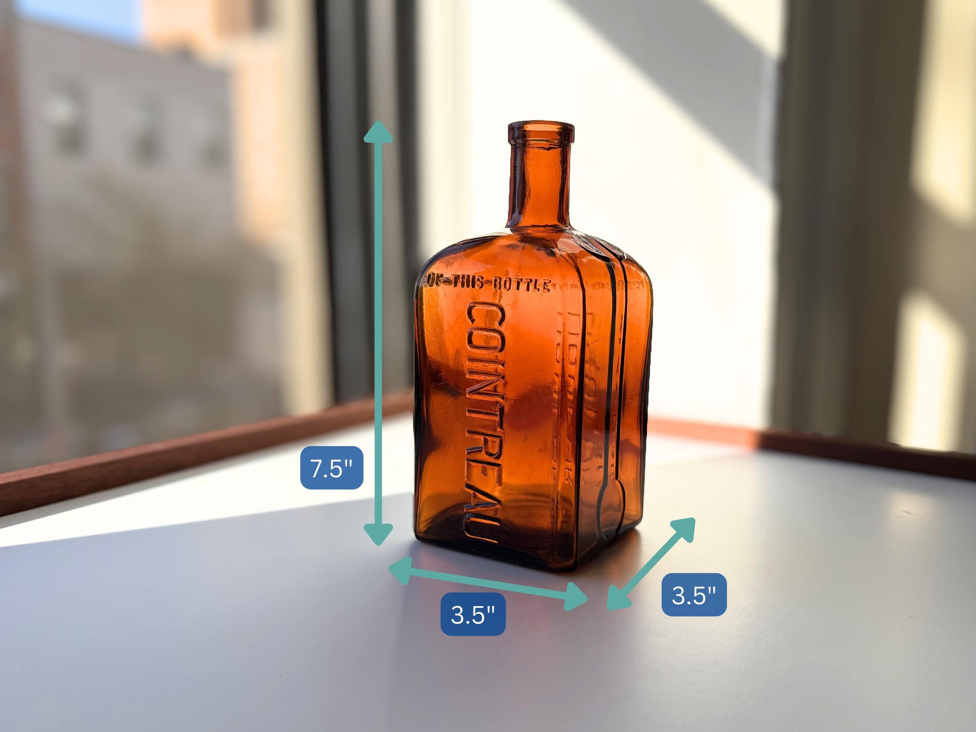 Vintage 1951 large amber Cointreau bottle with 51 production marking. Perfect for spirits collectors, bar displays, and vintage liqueur enthusiasts.