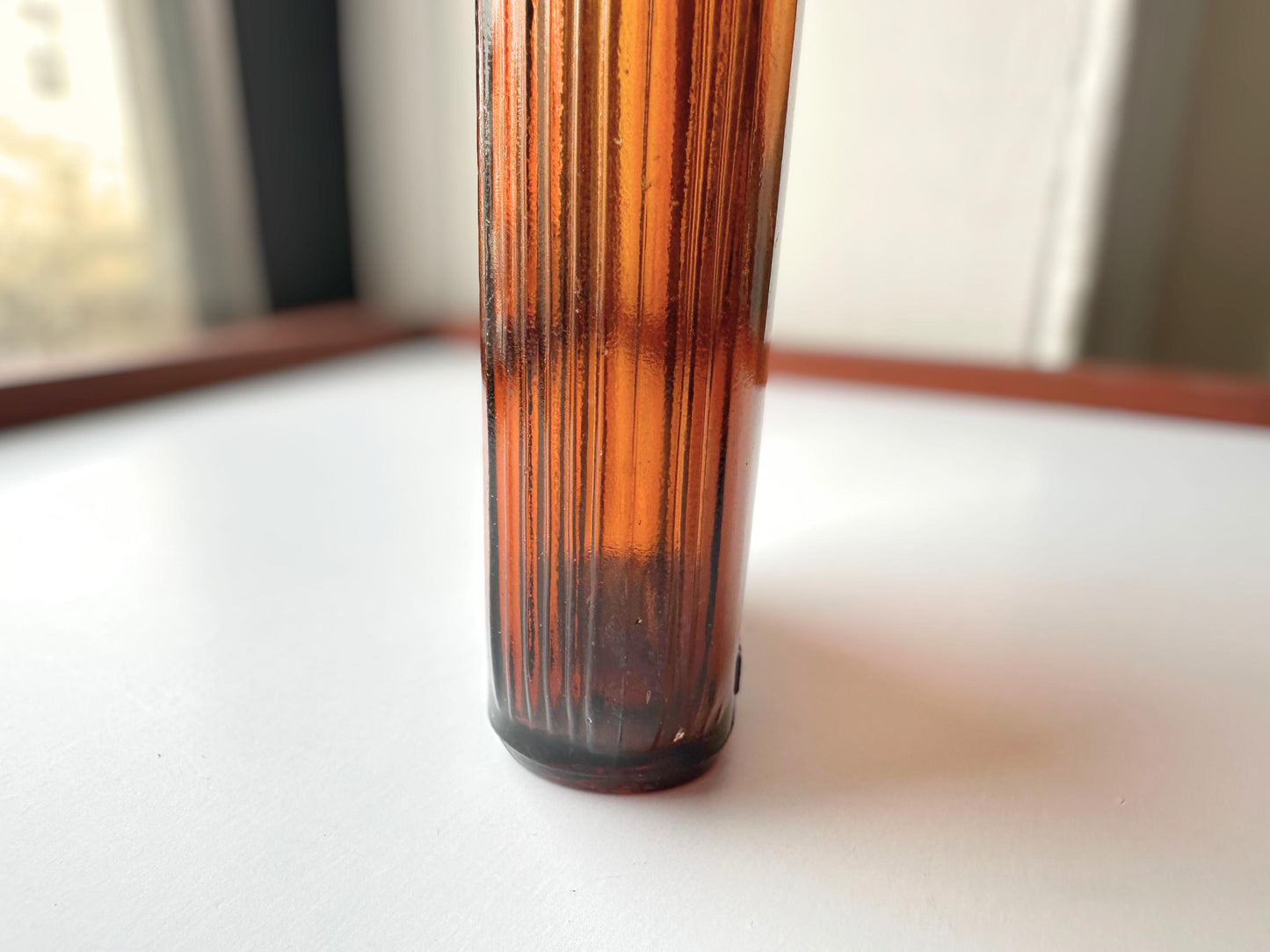 Vintage 1952 mid-century amber glass flask 7.5 inches tall by 3.4 inches wide, rescued from NYC beaches. Ribbed design with embossed Federal Law Forbids Sale Or Reuse Of This Bottle text – Brooklyn Sea Glass