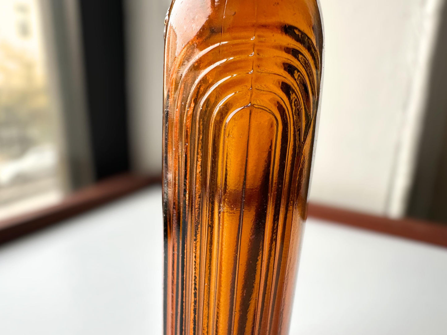 Vintage 1952 mid-century amber glass flask 7.5 inches tall by 3.4 inches wide, rescued from NYC beaches. Ribbed design with embossed Federal Law Forbids Sale Or Reuse Of This Bottle text – Brooklyn Sea Glass