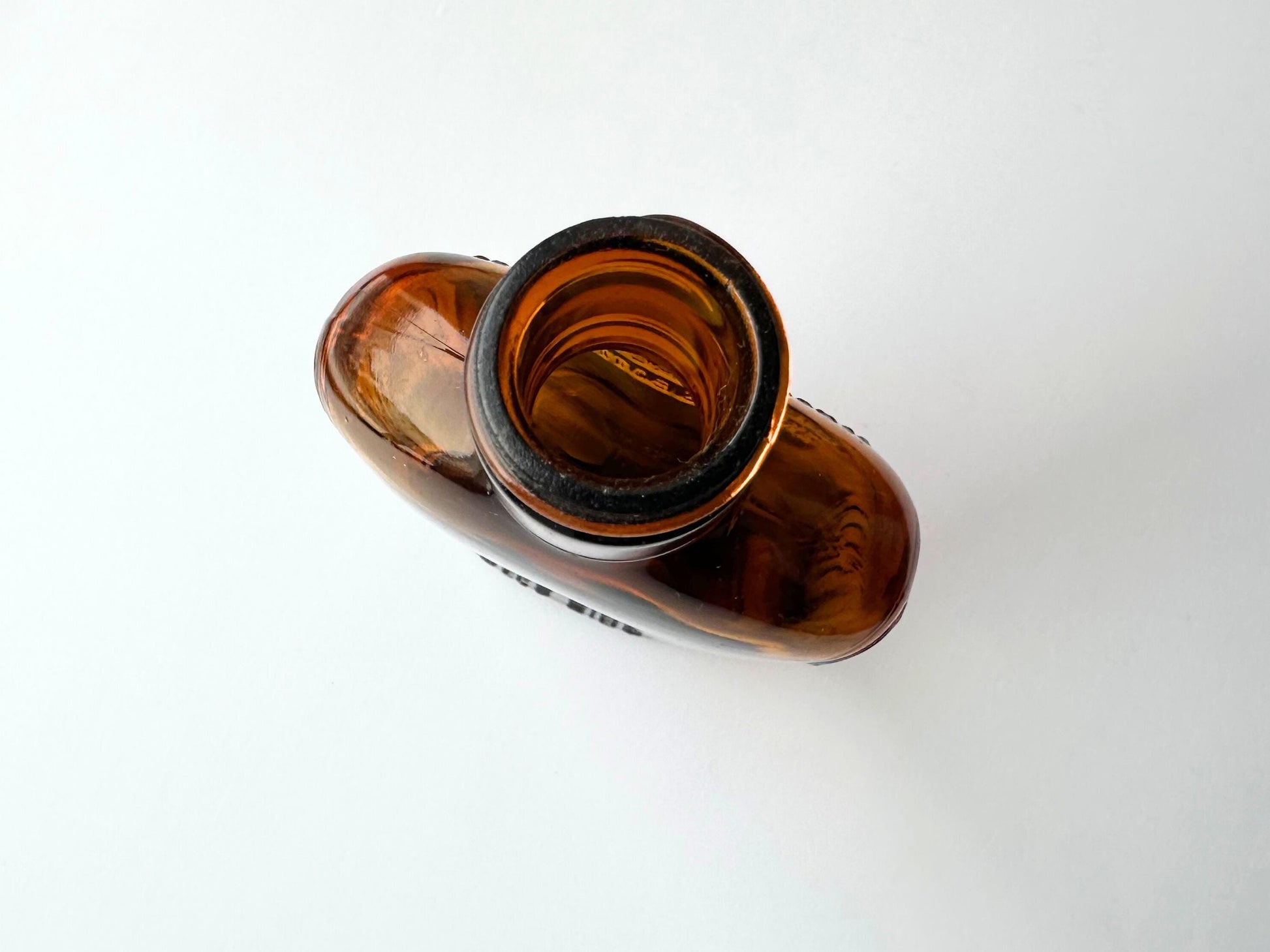 Vintage 1952 mid-century amber glass flask 7.5 inches tall by 3.4 inches wide, rescued from NYC beaches. Ribbed design with embossed Federal Law Forbids Sale Or Reuse Of This Bottle text – Brooklyn Sea Glass