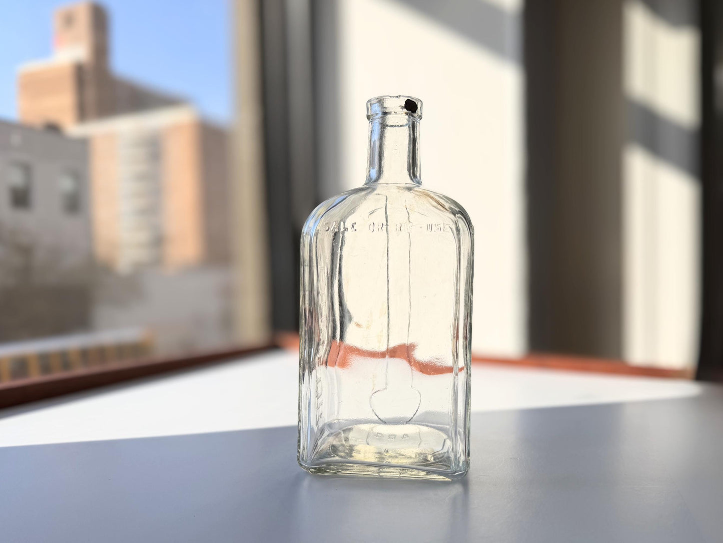 Vintage 1952 Cointreau clear glass liqueur flask 7.5 inches tall with COINTREAU and LIQUEUR embossing - French spirits collector piece hand-recovered from NYC, small chip on mouth