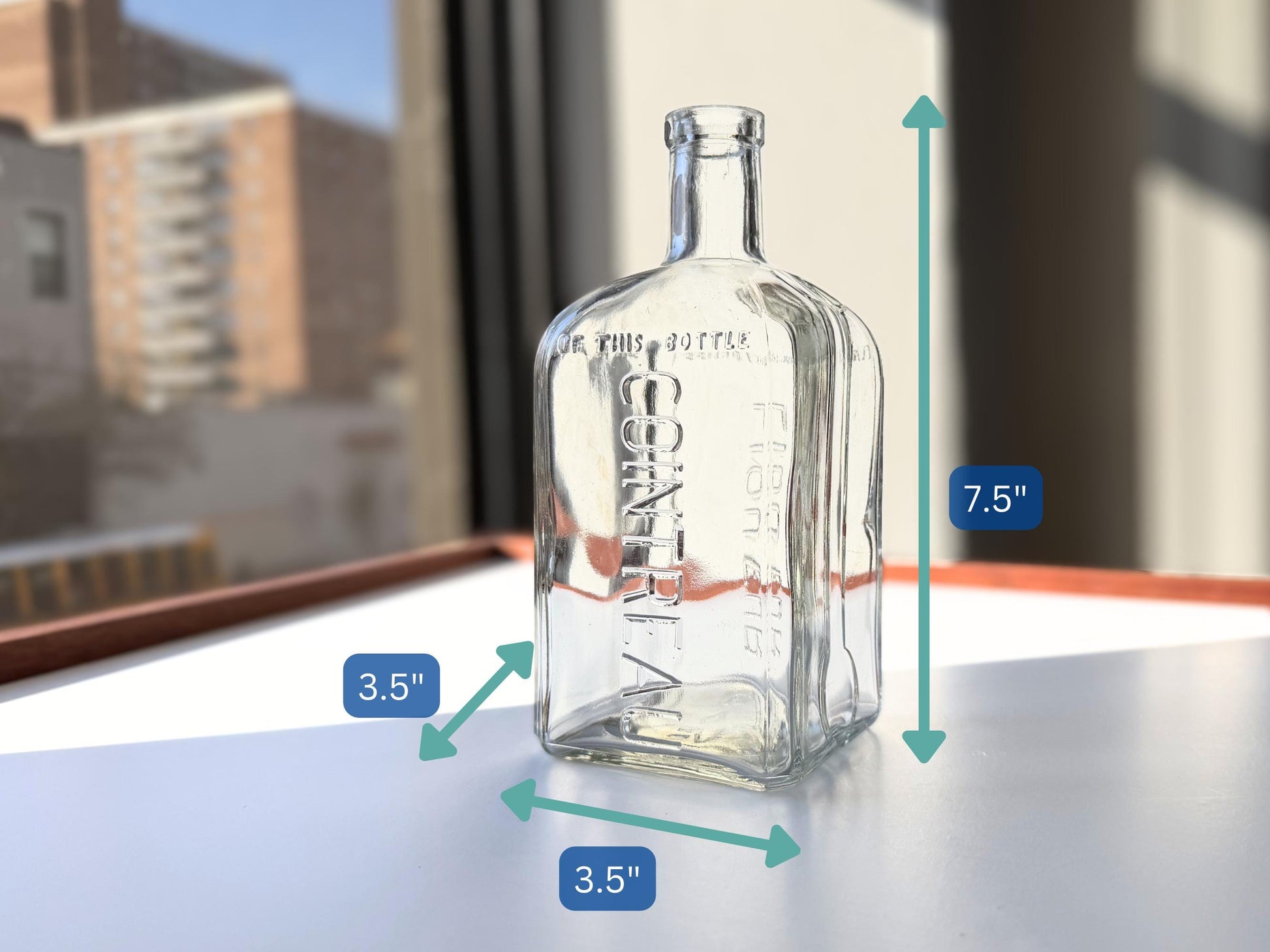 Vintage 1952 Cointreau clear glass liqueur flask 7.5 inches tall with COINTREAU and LIQUEUR embossing - French spirits collector piece hand-recovered from NYC, small chip on mouth
