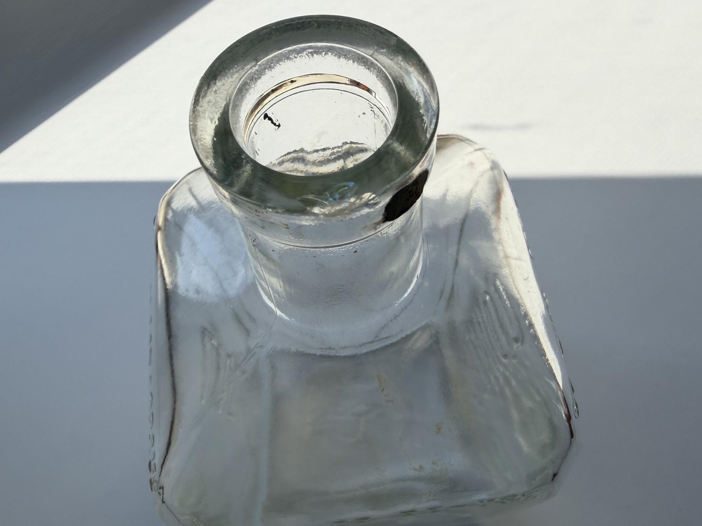 Vintage 1952 Cointreau clear glass liqueur flask 7.5 inches tall with COINTREAU and LIQUEUR embossing - French spirits collector piece hand-recovered from NYC, small chip on mouth