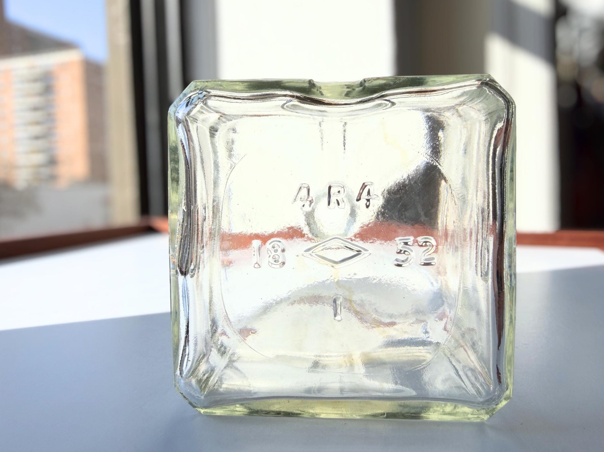 Vintage 1952 Cointreau clear glass liqueur flask 7.5 inches tall with COINTREAU and LIQUEUR embossing - French spirits collector piece hand-recovered from NYC, small chip on mouth
