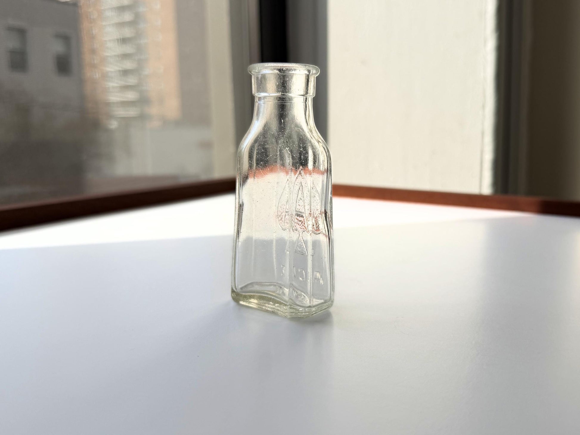 Vintage clear glass Ace shoe polish bottle 4.25 inches tall with bold ace-of-spades embossed logo - mid-century American collector piece hand-recovered from NYC