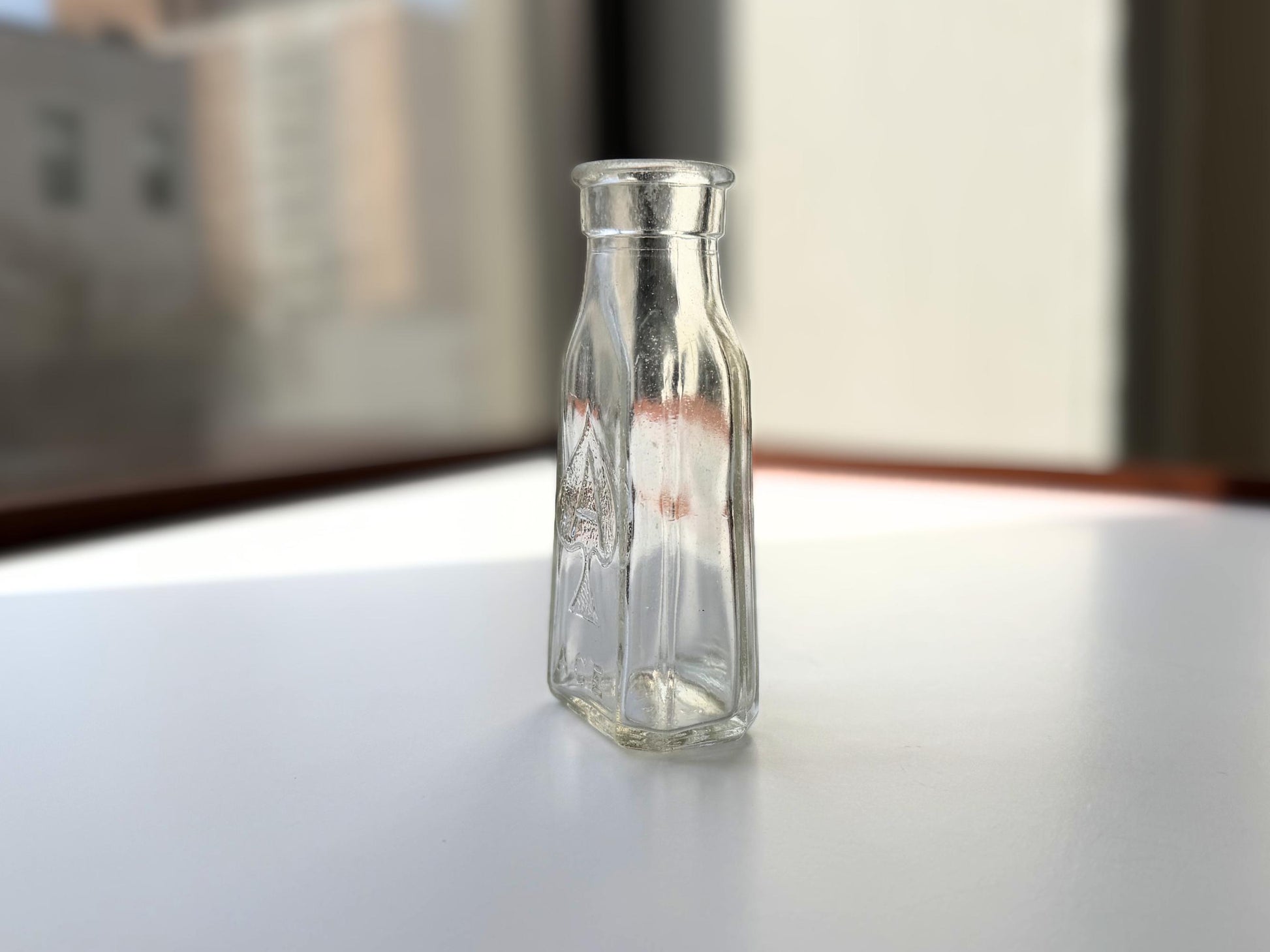 Vintage clear glass Ace shoe polish bottle 4.25 inches tall with bold ace-of-spades embossed logo - mid-century American collector piece hand-recovered from NYC