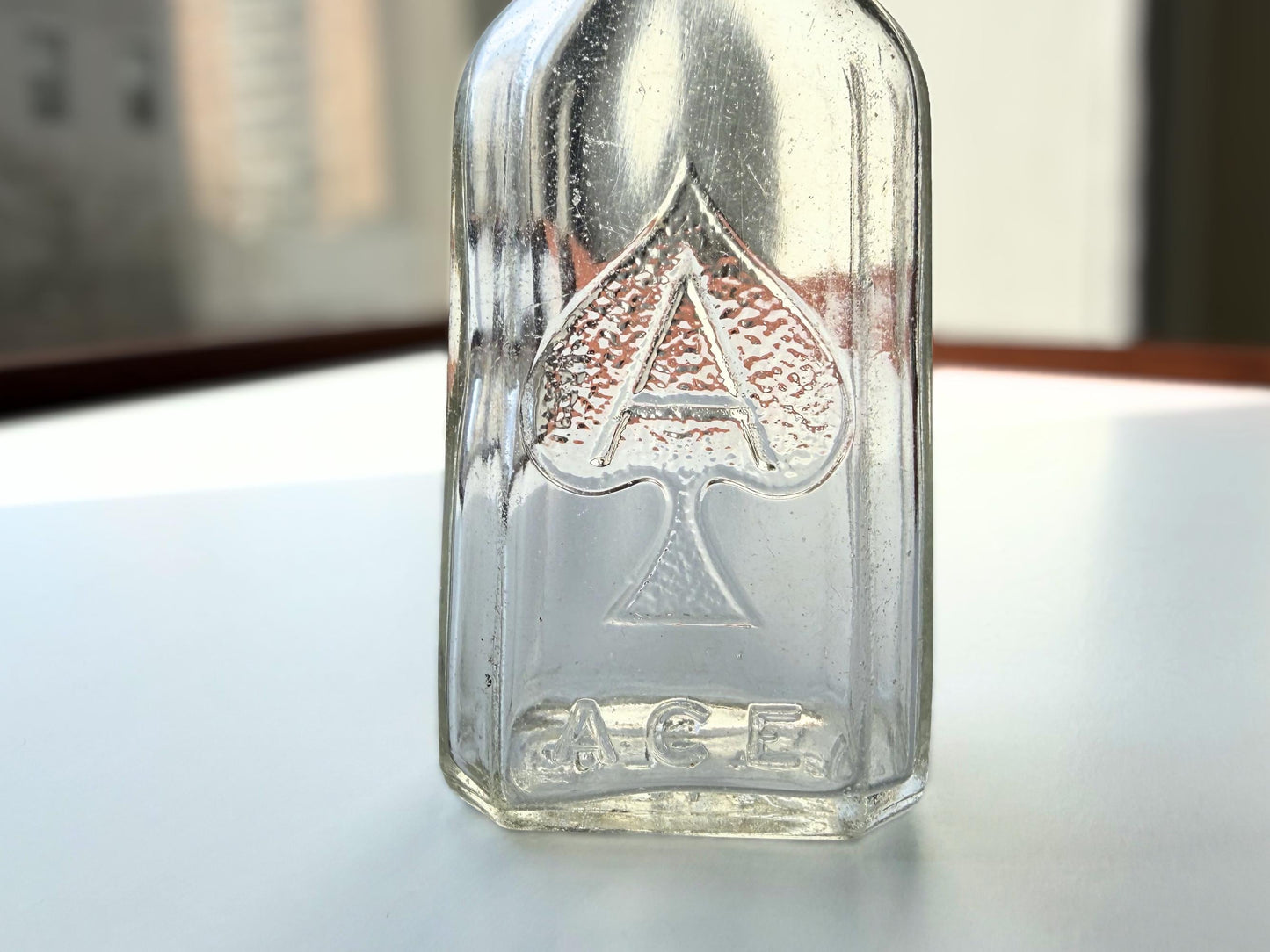 Vintage clear glass Ace shoe polish bottle 4.25 inches tall with bold ace-of-spades embossed logo - mid-century American collector piece hand-recovered from NYC