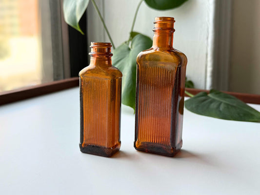 Vintage 1949 amber medicine bottle set with ribbed texture and Owens-Illinois maker's mark, perfect for apothecary decor, bookshelf styling, farmhouse bathroom displays, bud vases for dried flowers. Two authentic pharmaceutical bottles in rich am