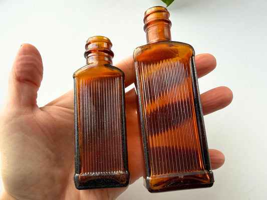 Vintage 1949 amber medicine bottle set with ribbed texture and Owens-Illinois maker's mark, perfect for apothecary decor, bookshelf styling, farmhouse bathroom displays, bud vases for dried flowers. Two authentic pharmaceutical bottles in rich am