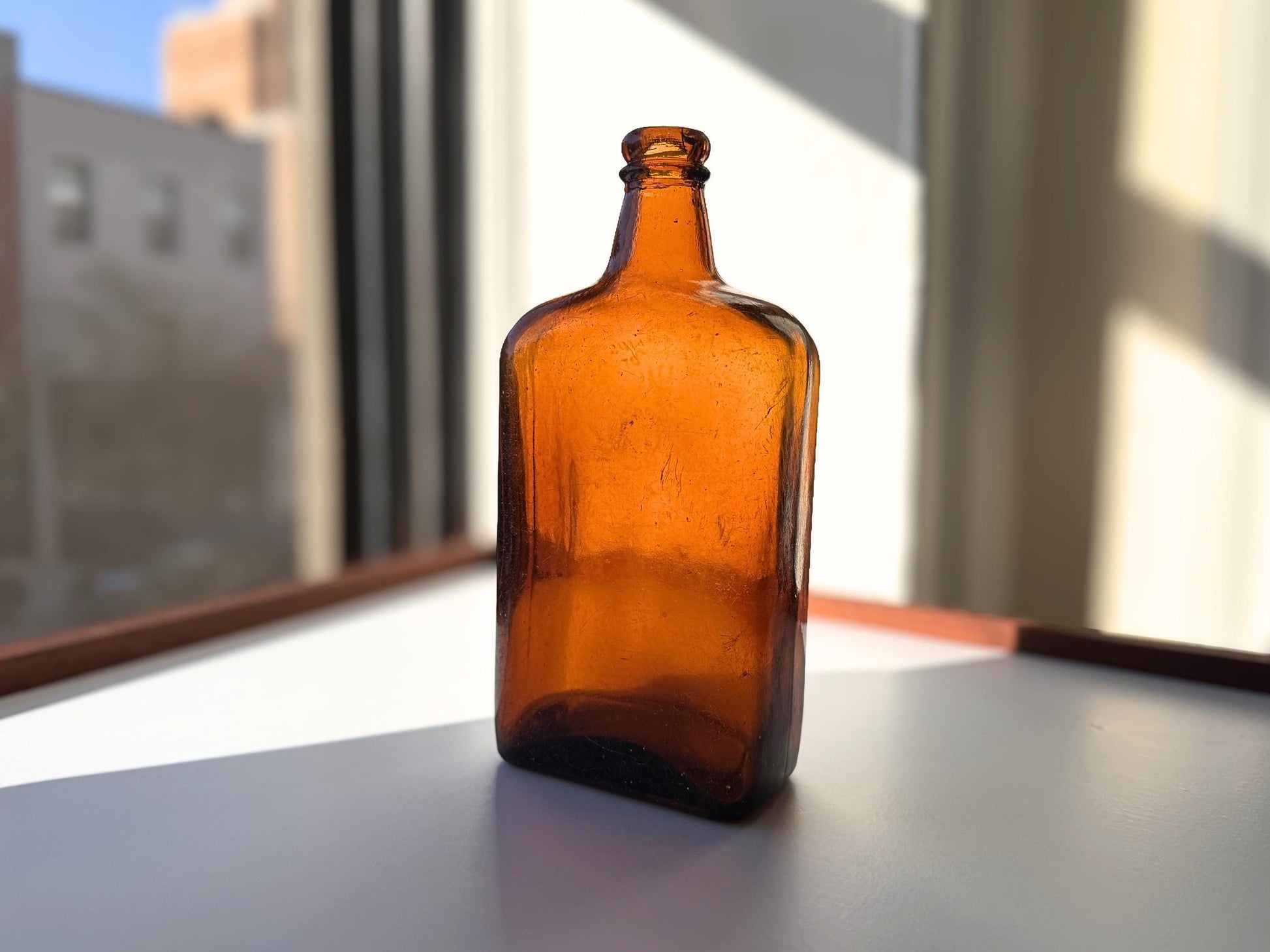 Vintage Bloch Brothers whisky bottle from Glasgow Scotland with distillery marking. Good condition showing minor scratches. Perfect for Scottish whisky collectors.