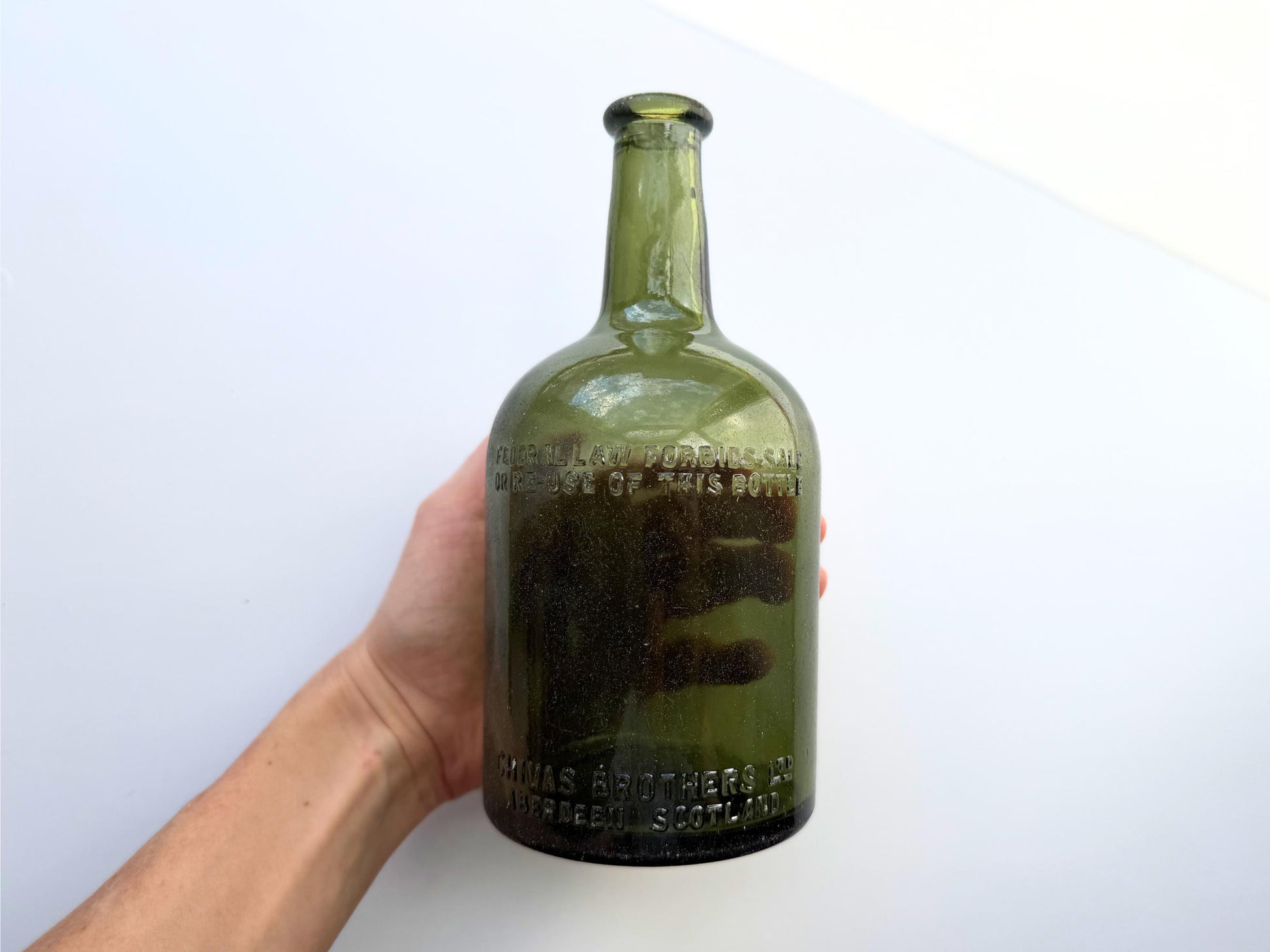 Vintage Chivas Brothers olive green scotch bottle, 8.25 inches tall, embossed with Federal Law Forbids Sale Or Re-Use Of This Bottle — hand-recovered NYC mid-century glass dated 1935 to 1964